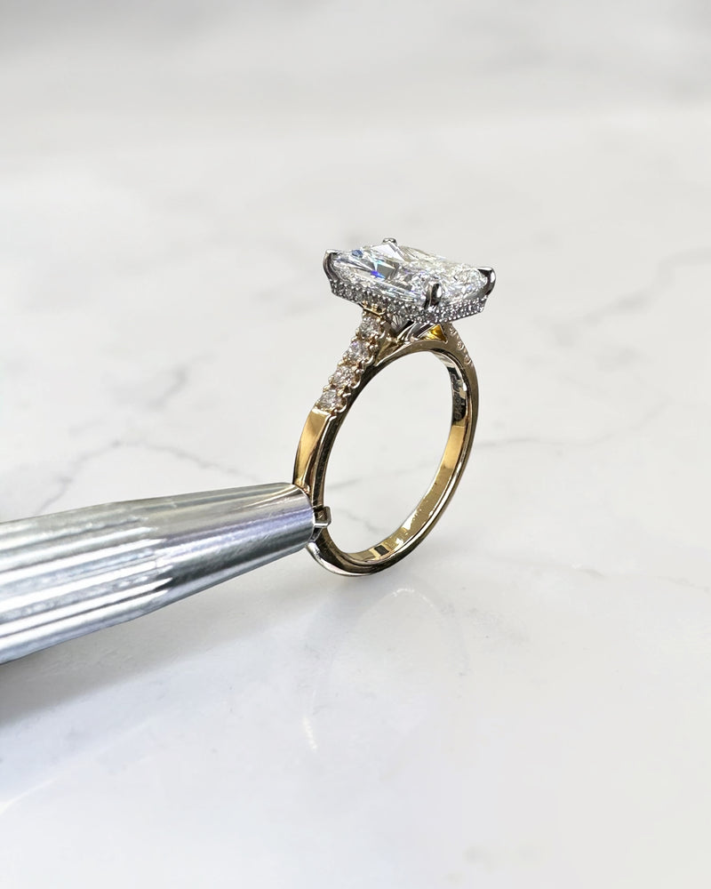3ct radiant cut lab grown diamond engagement ring with partial pavé band, cathedral setting, hidden halo and two tone yellow gold band