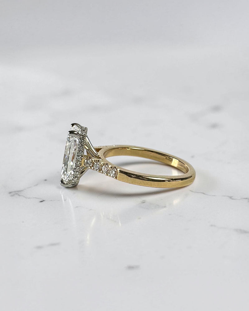 3ct radiant cut lab grown diamond engagement ring with partial pavé band, cathedral setting, hidden halo and two tone yellow gold band