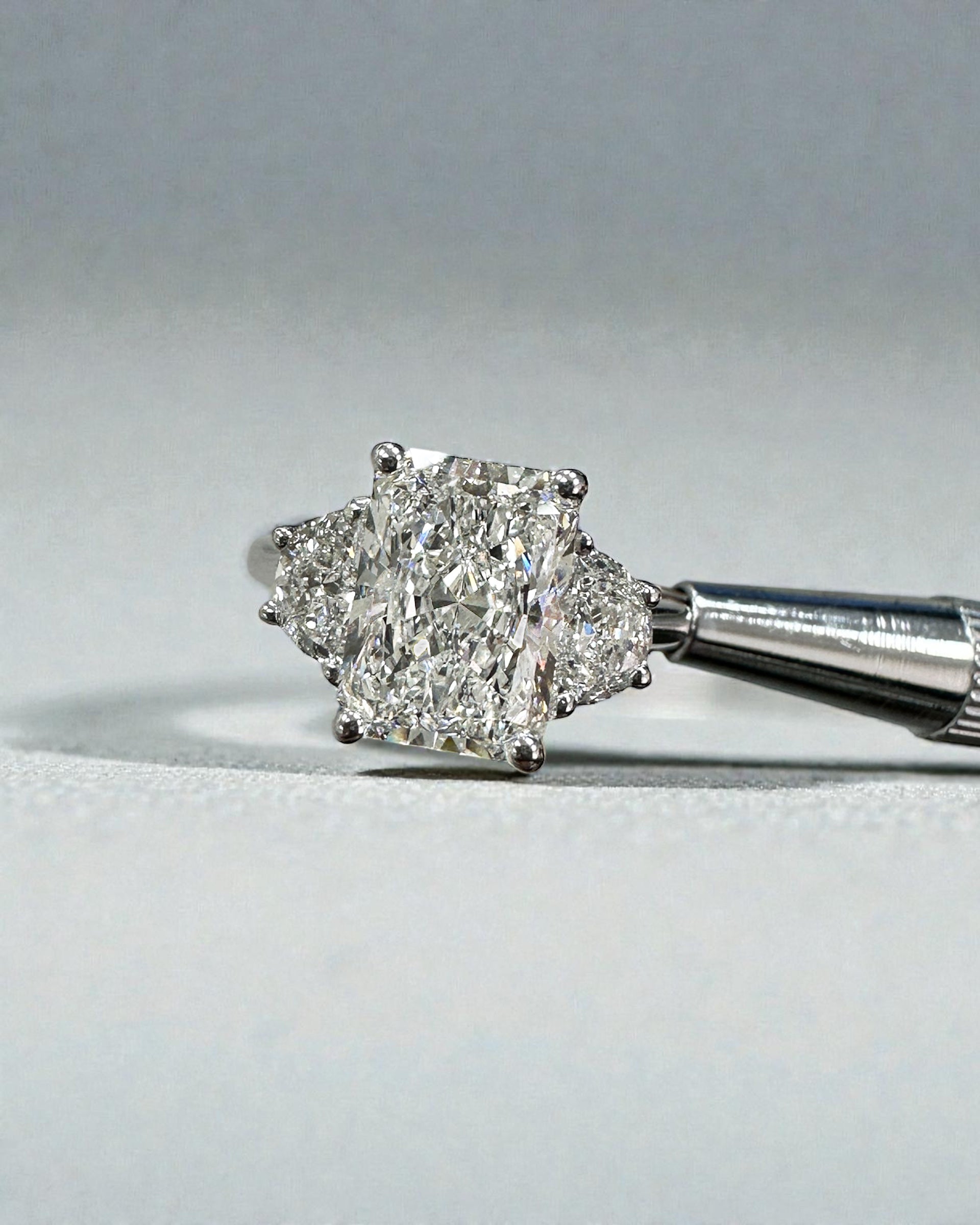 3ct radiant cut lab grown diamond trilogy engagement ring with half moon side stones in polished platinum