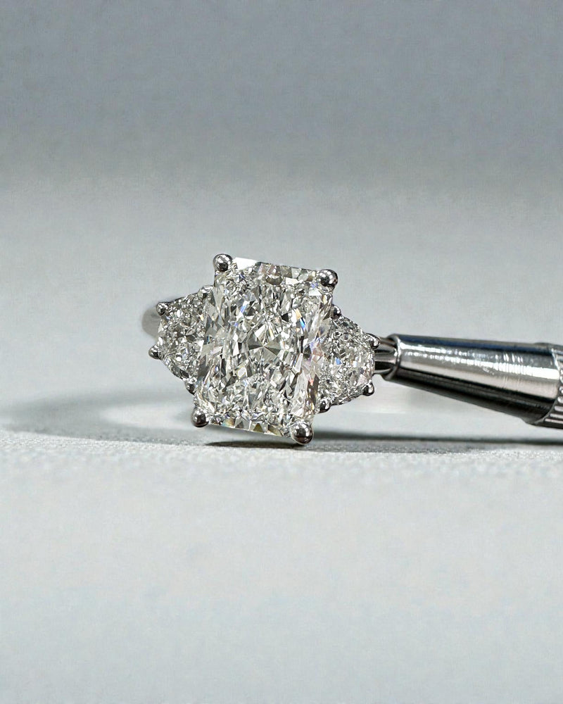 3ct radiant cut lab grown diamond trilogy engagement ring with half moon side stones in polished platinum