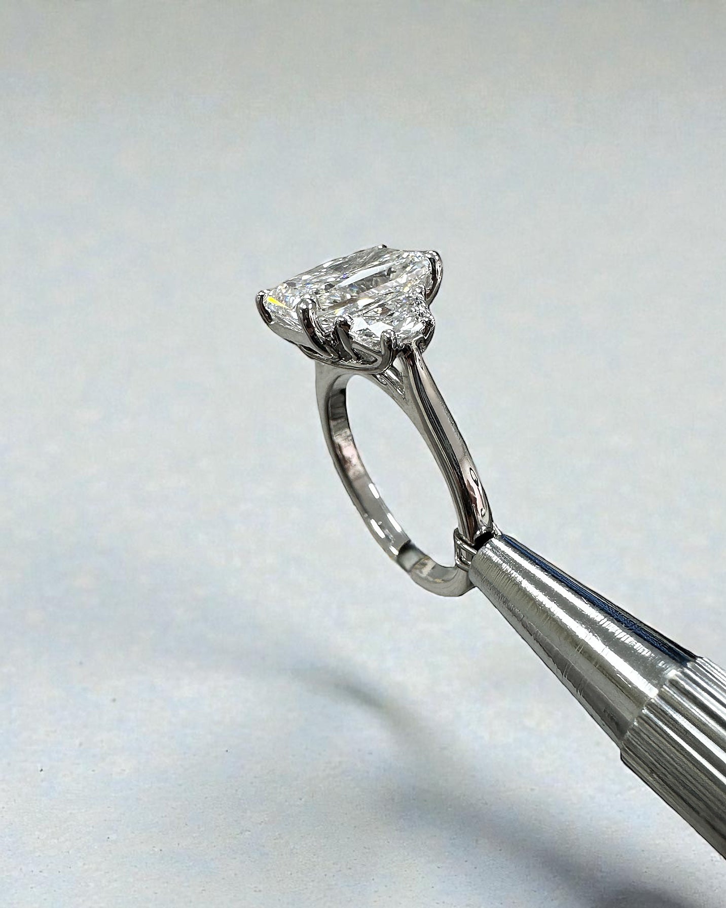 3ct radiant cut lab grown diamond trilogy engagement ring with half moon side stones in polished platinum
