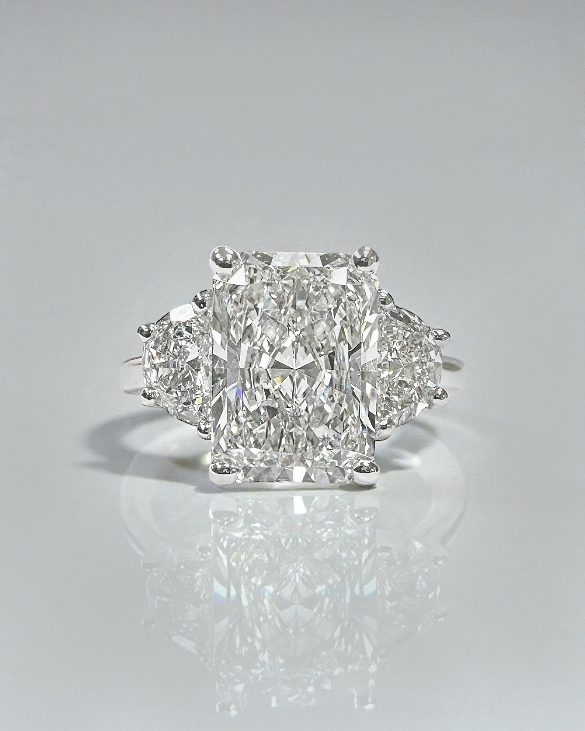 3ct radiant cut lab grown diamond trilogy engagement ring with half moon side stones in polished platinum