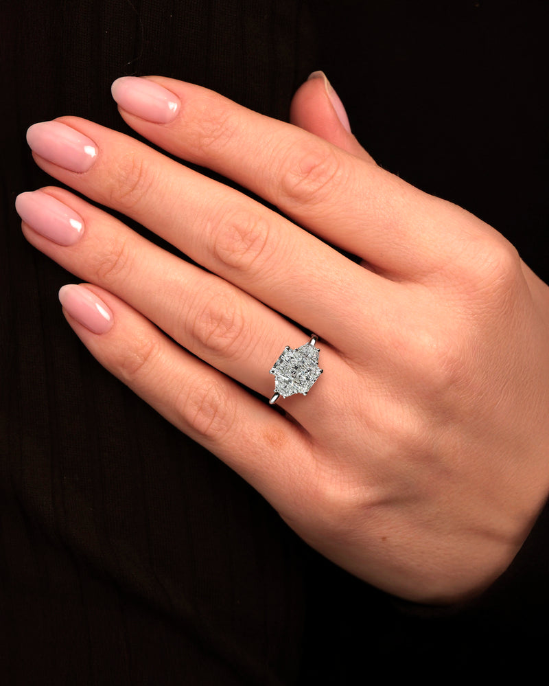 3ct radiant cut lab grown diamond trilogy engagement ring with half moon side stones in polished platinum on hand