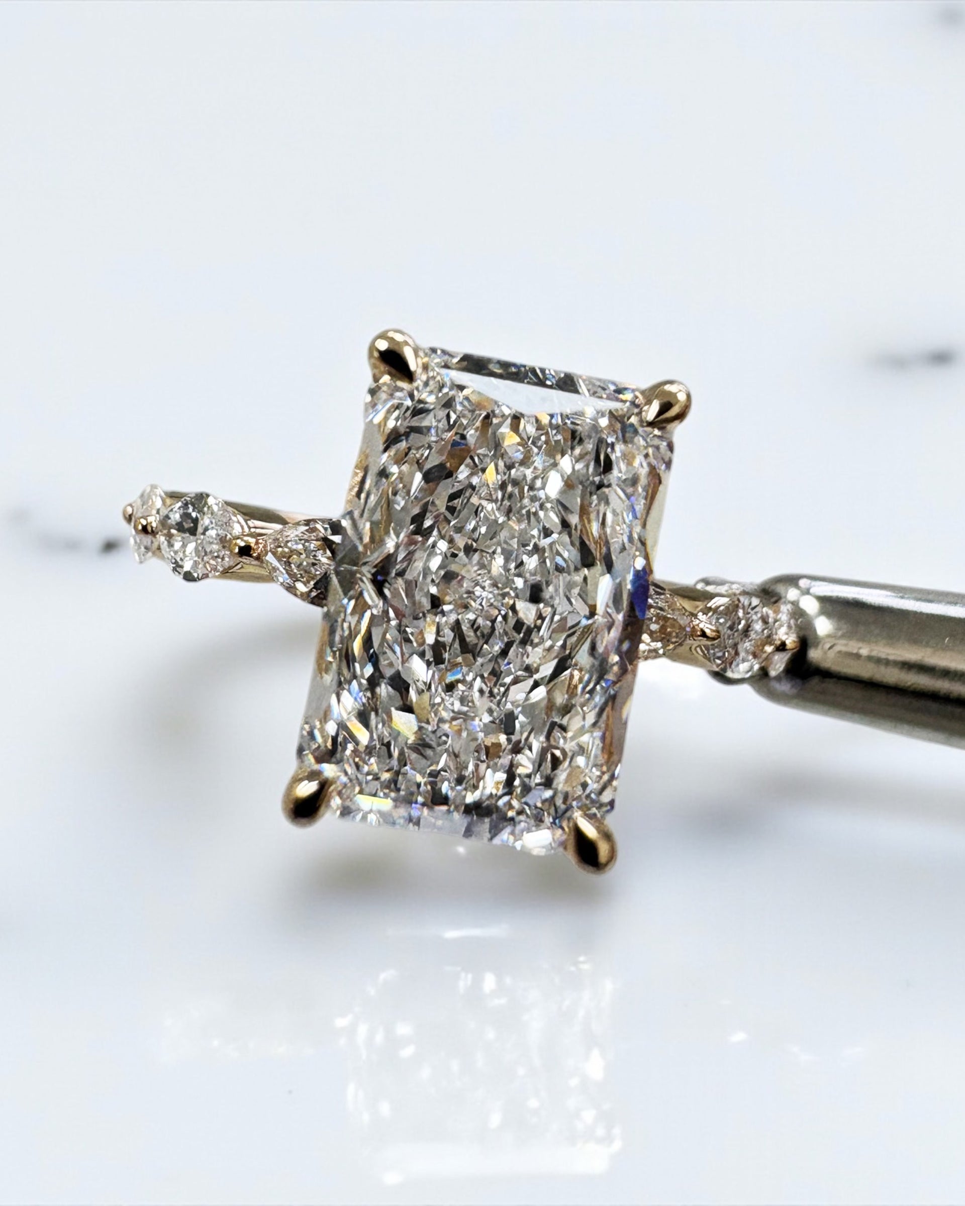 3ct Radiant cut lab grown diamond set with marquise side diamonds on the band, engagement ring, 18kt yellow gold 