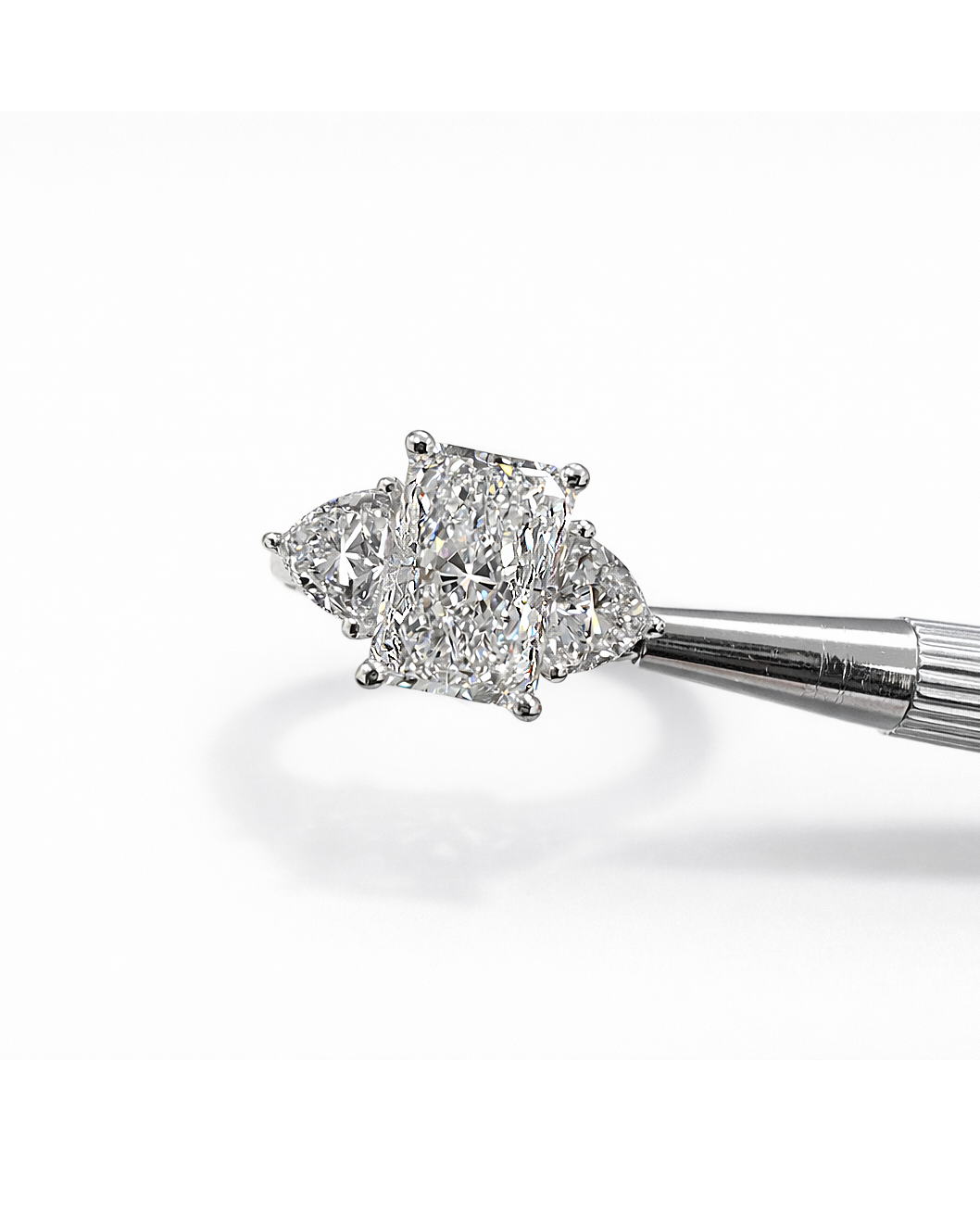 3ct radiant cut lab grown diamond engagement ring UK with trillion side stones, 4.40ct trilogy engagement ring design in polished white gold or platinum handcrafted in London