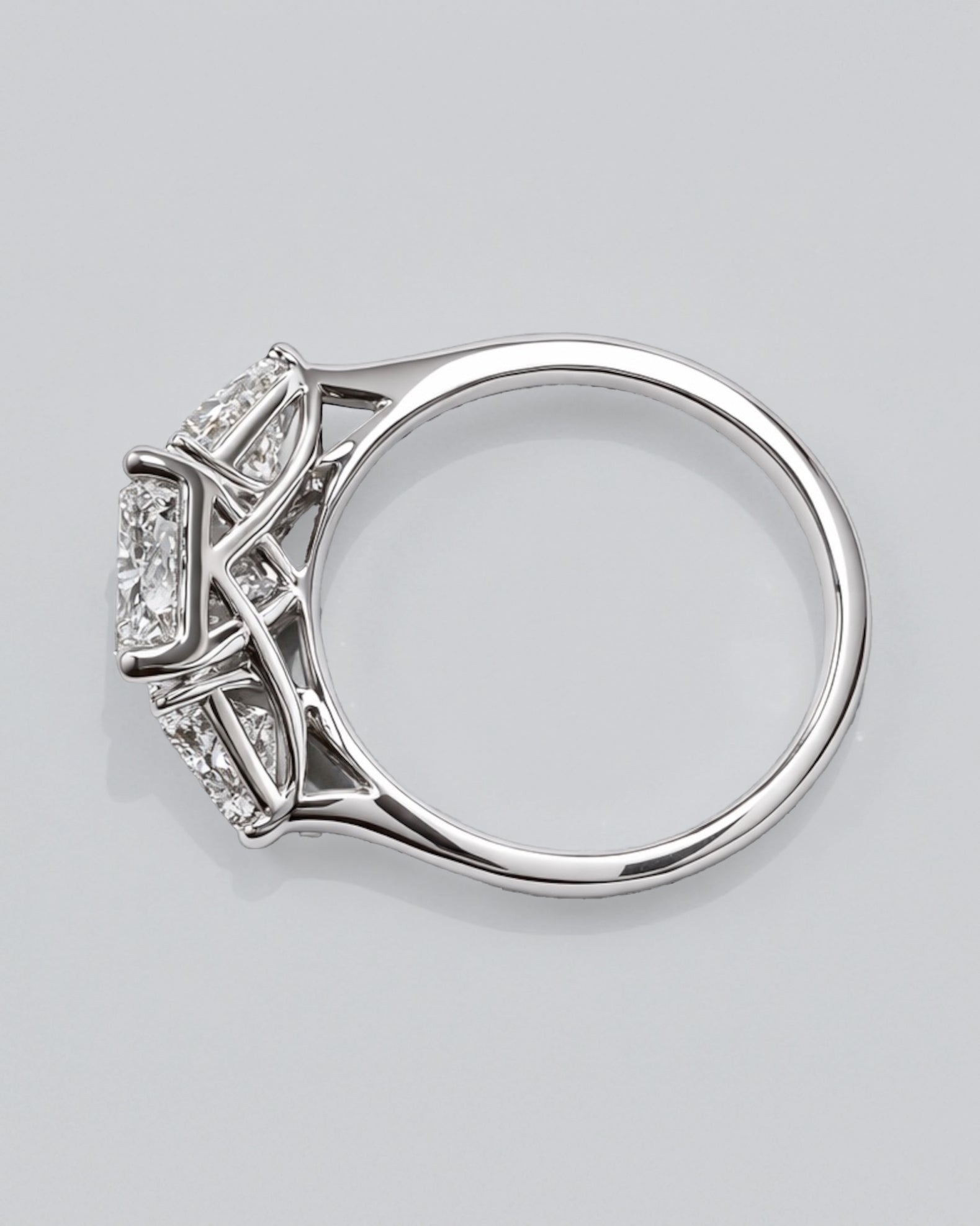 3ct radiant cut lab grown diamond engagement ring UK with trillion side stones, 4.40ct trilogy engagement ring design in polished white gold or platinum handcrafted in London