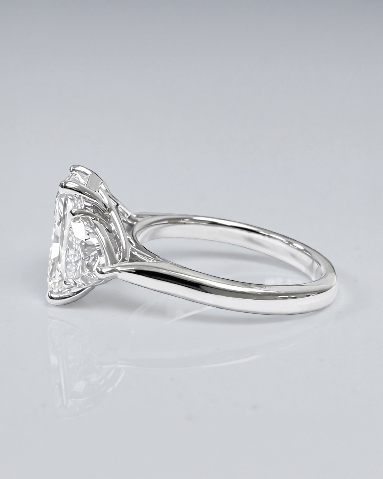 3ct radiant cut lab grown diamond engagement ring UK with trillion side stones, 4.40ct trilogy engagement ring design in polished white gold or platinum handcrafted in London