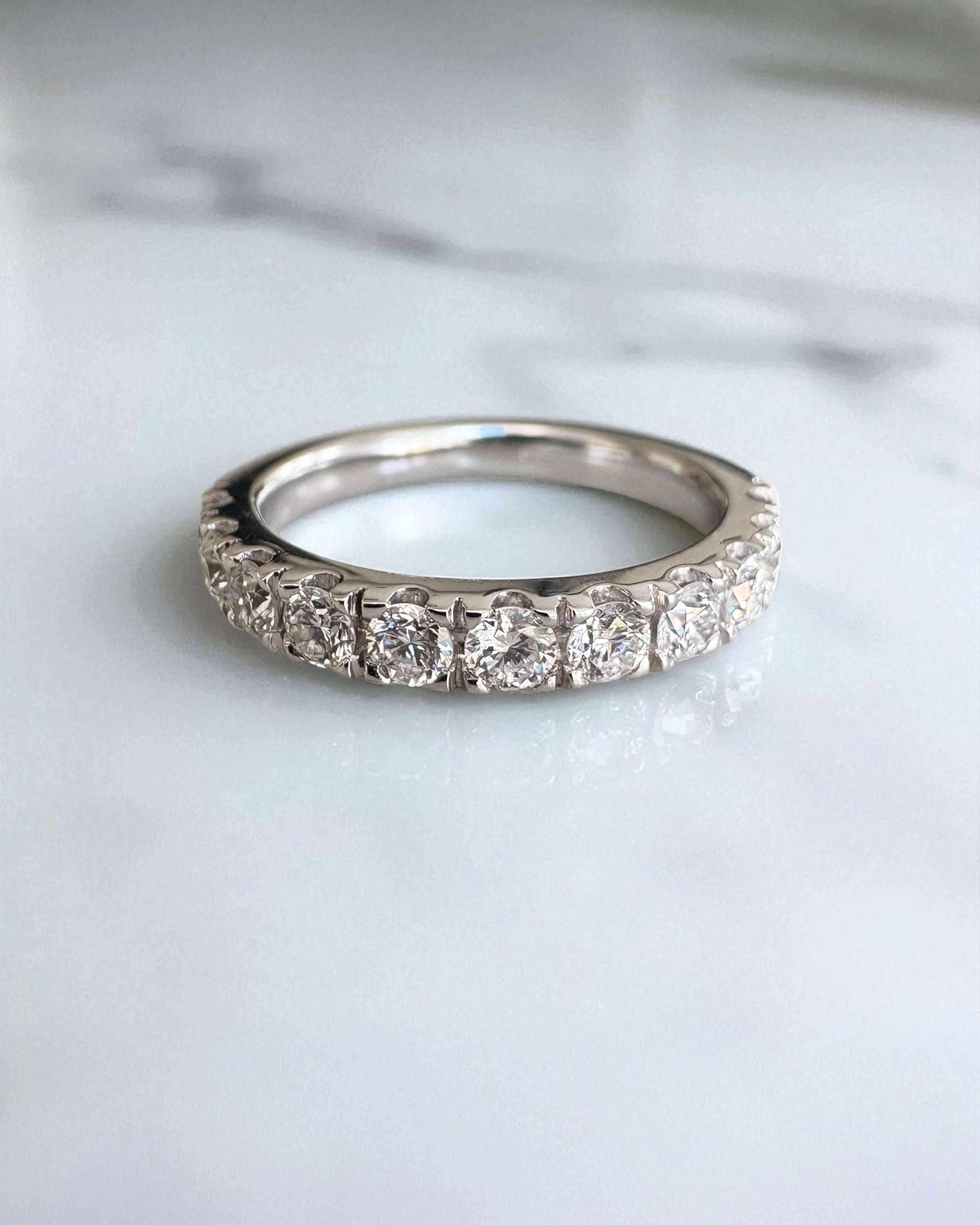 Close-up detail of the round diamonds on this 3mm wide wedding bands for women style.