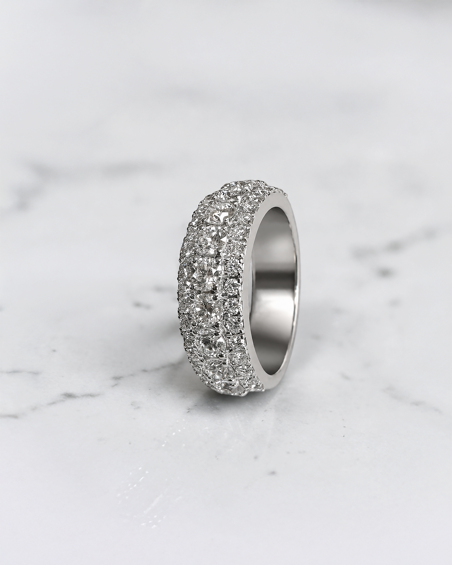 2.70ct three row round brilliant diamond band ring with graduated centre diamonds and 7.7mm wide band
Platinum or 18kt white gold