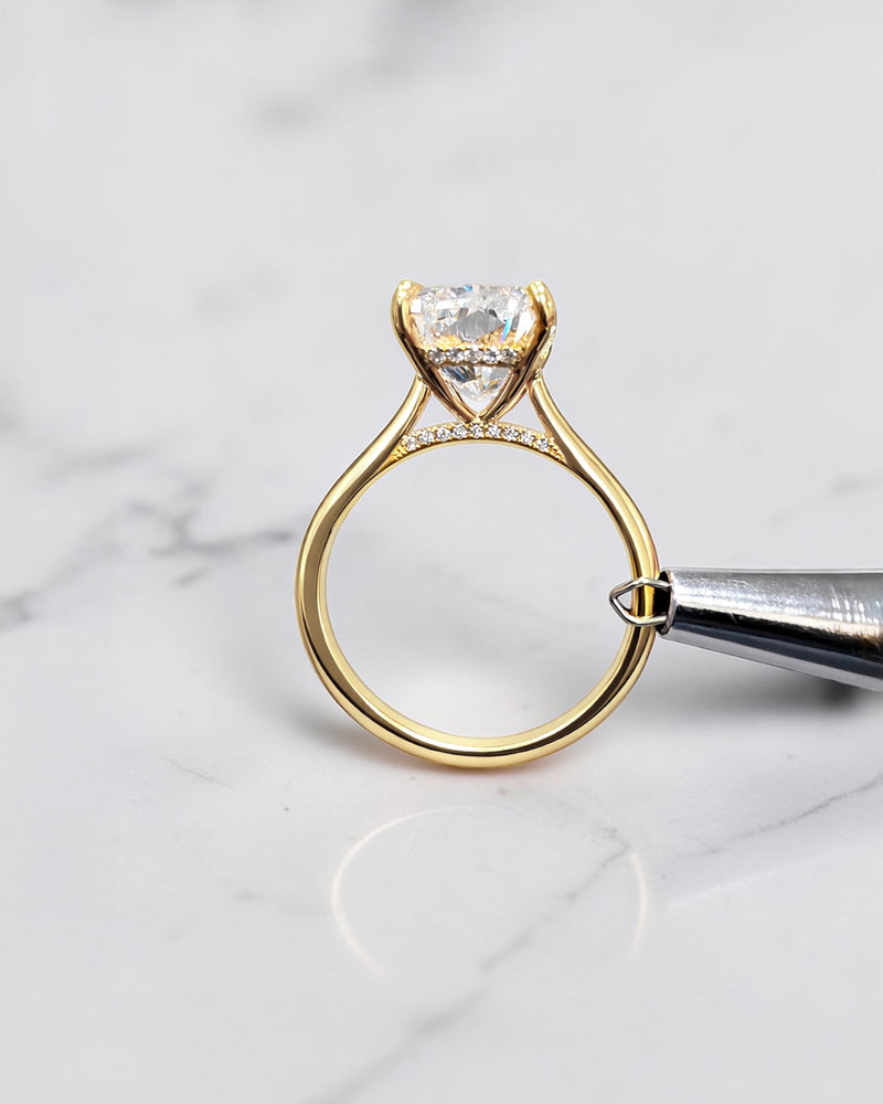 4ct elongated cushion cut lab grown diamond engagement ring in 18kt yellow gold with cathedral setting and hidden halo.