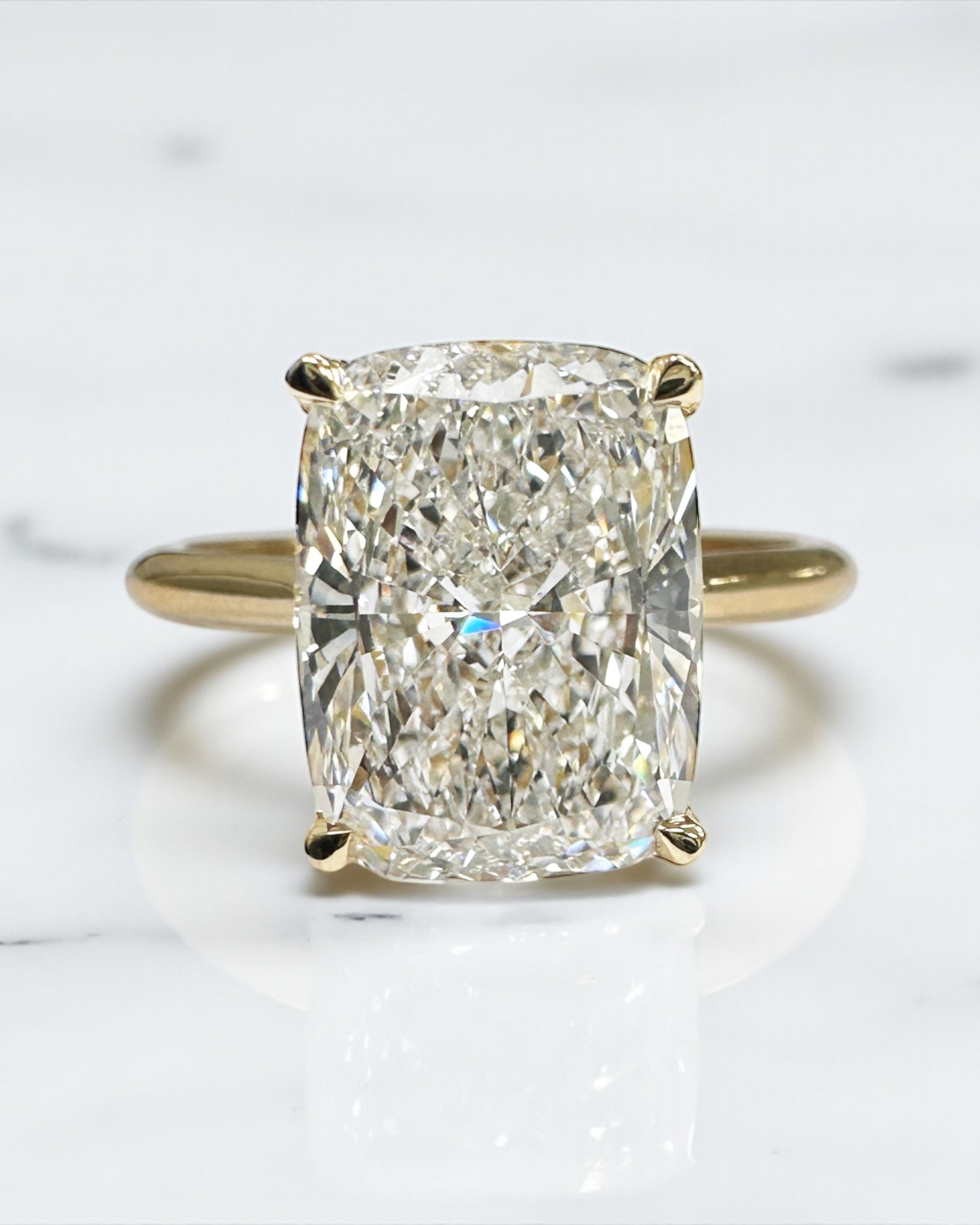 4ct elongated cushion cut lab grown diamond cathedral engagement ring in 18kt yellow gold, diamond bridge and hidden halo