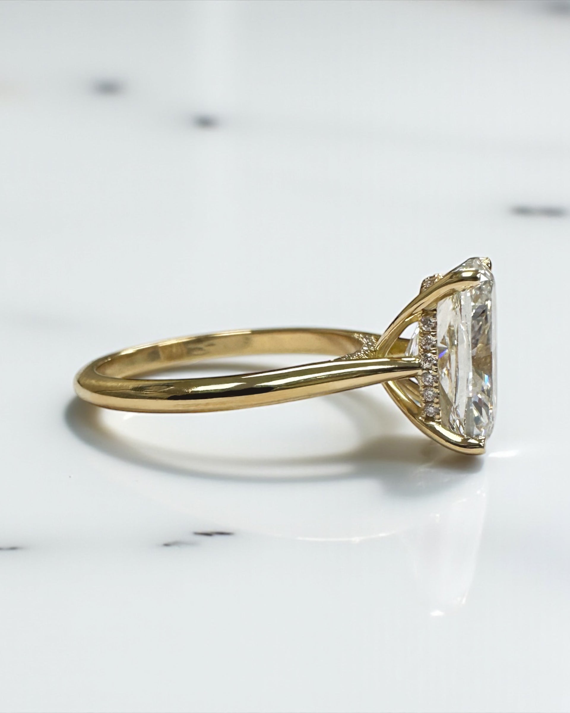 4ct elongated cushion cut lab grown diamond cathedral engagement ring in 18kt yellow gold, diamond bridge and hidden halo