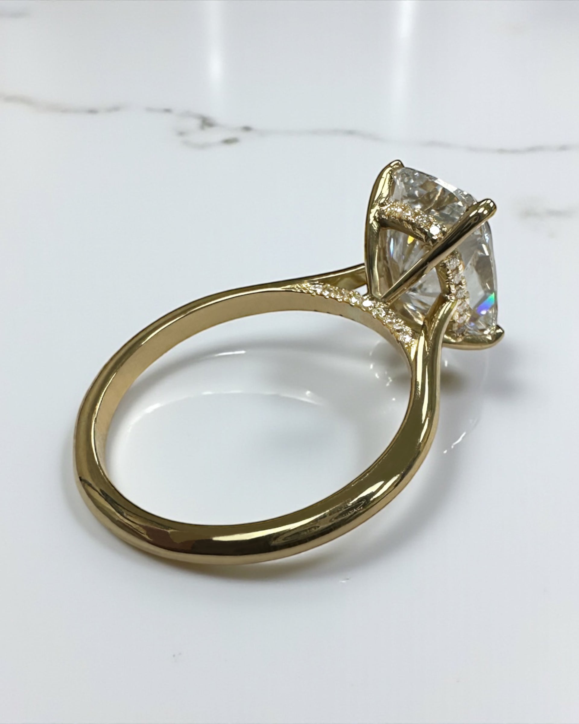4ct elongated cushion cut lab grown diamond cathedral engagement ring in 18kt yellow gold, diamond bridge and hidden halo
