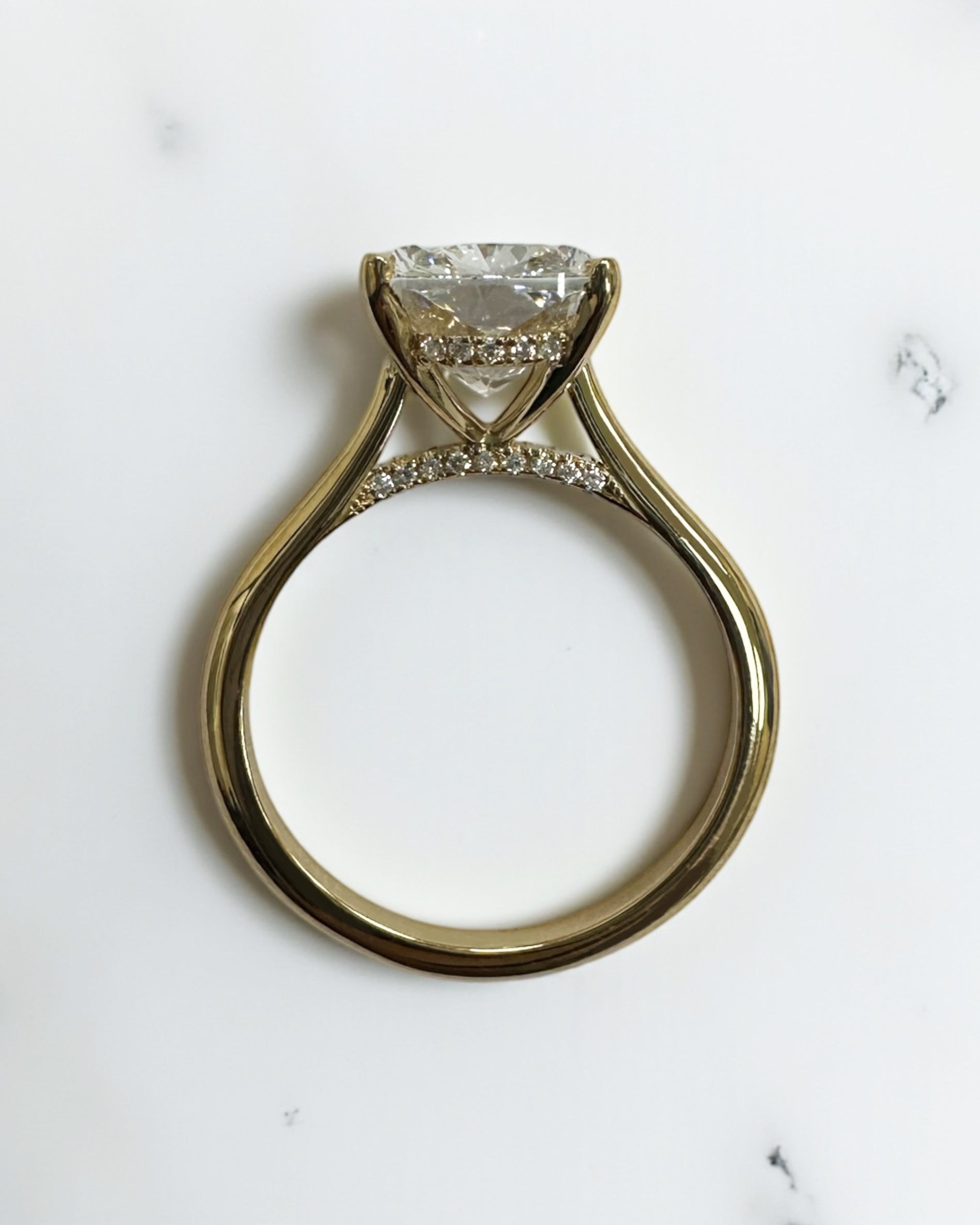 4ct elongated cushion cut lab grown diamond cathedral engagement ring in 18kt yellow gold, diamond bridge and hidden halo