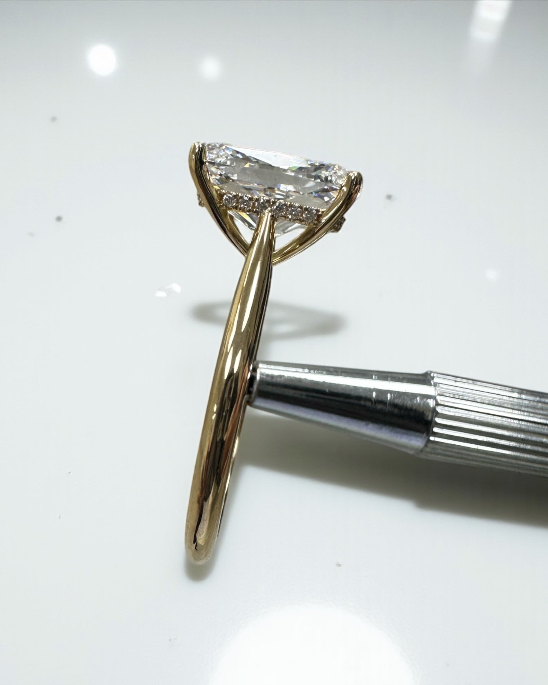 4ct elongated cushion cut lab grown diamond cathedral engagement ring in 18kt yellow gold, diamond bridge and hidden halo