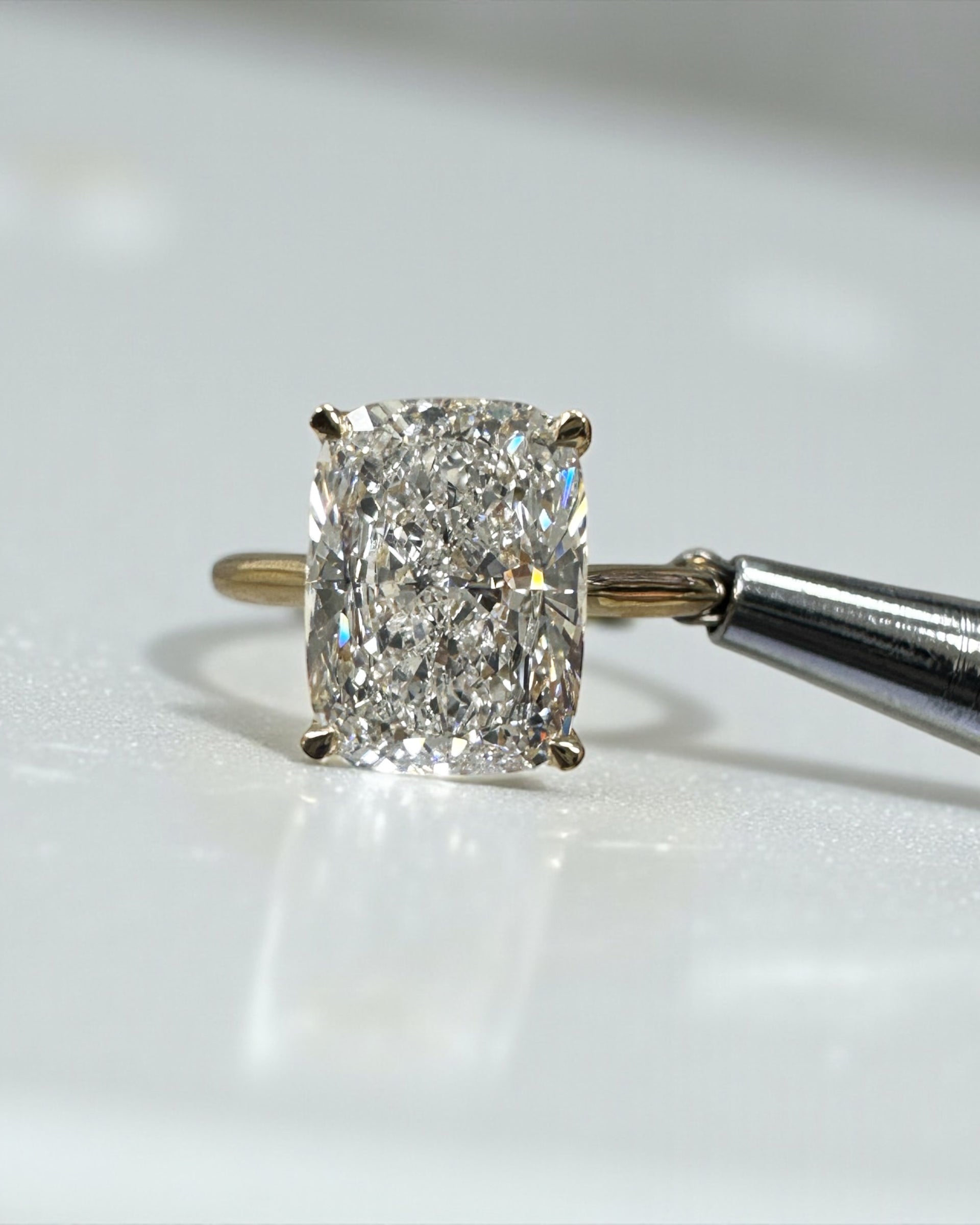 4ct elongated cushion cut lab grown diamond cathedral engagement ring in 18kt yellow gold, diamond bridge and hidden halo