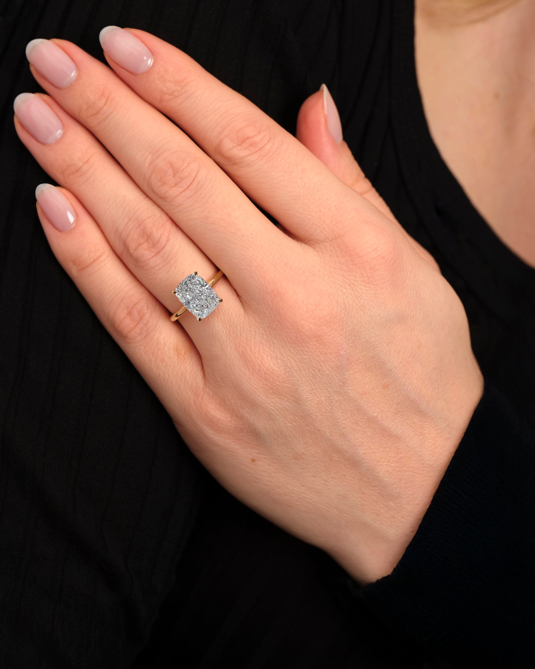 4ct elongated cushion cut lab grown diamond cathedral engagement ring in 18kt yellow gold, diamond bridge and hidden halo on hand