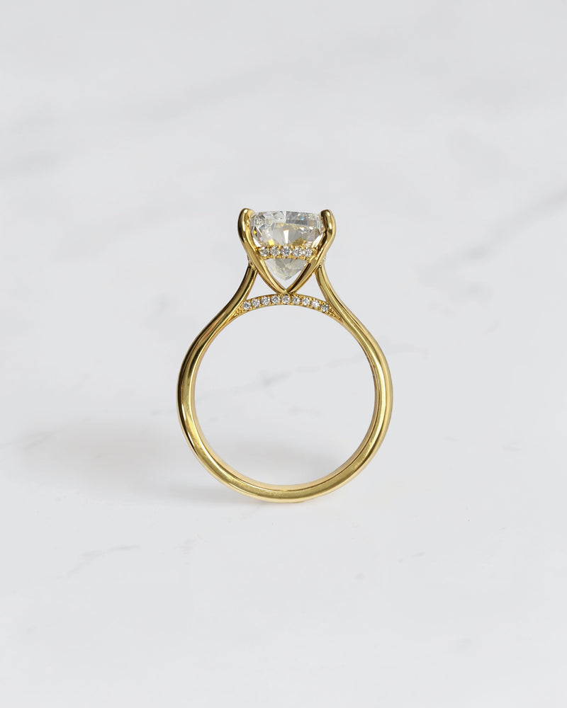 4ct elongated cushion cut lab grown diamond engagement ring in 18kt yellow gold with cathedral setting and hidden halo.