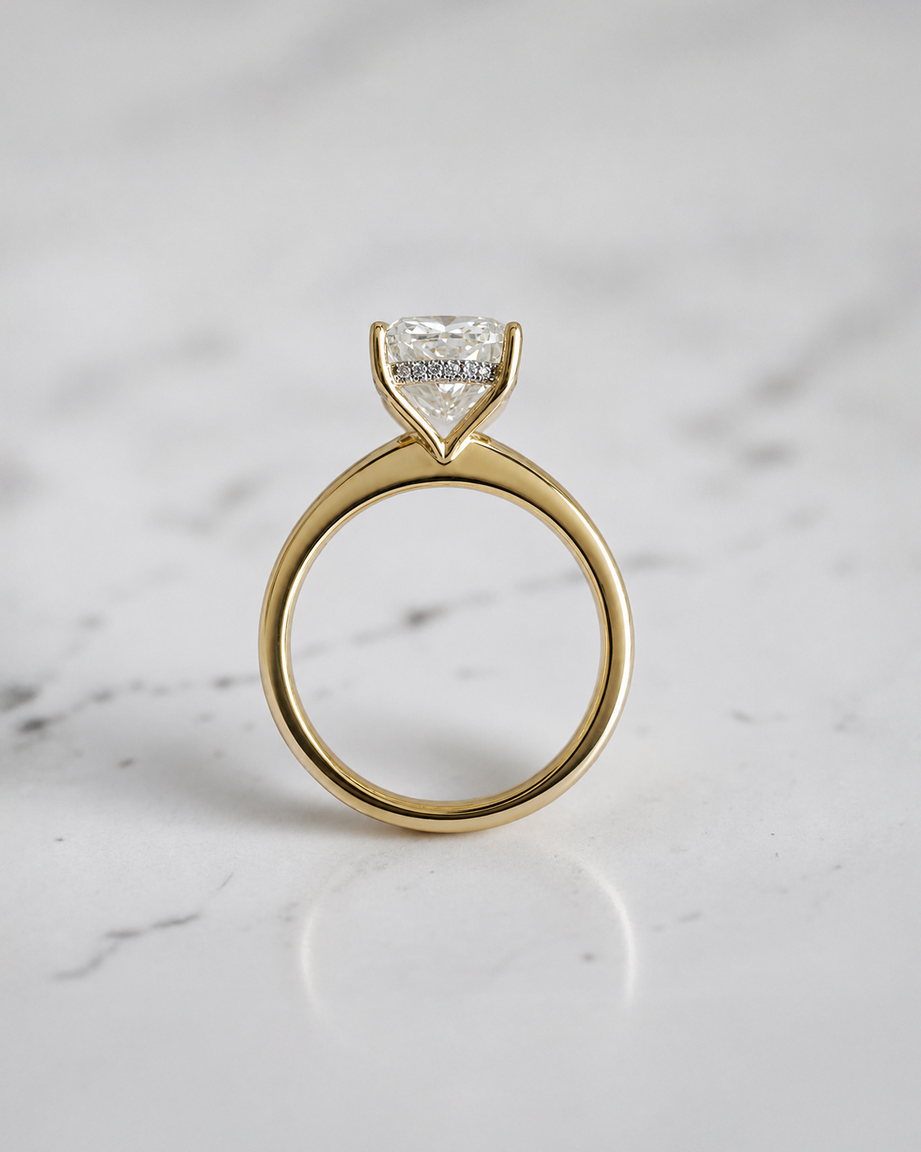 4ct elongated cushion cut lab grown diamond hidden halo solitaire engagement ring in yellow gold with floating cathedral style setting, handmade in London.