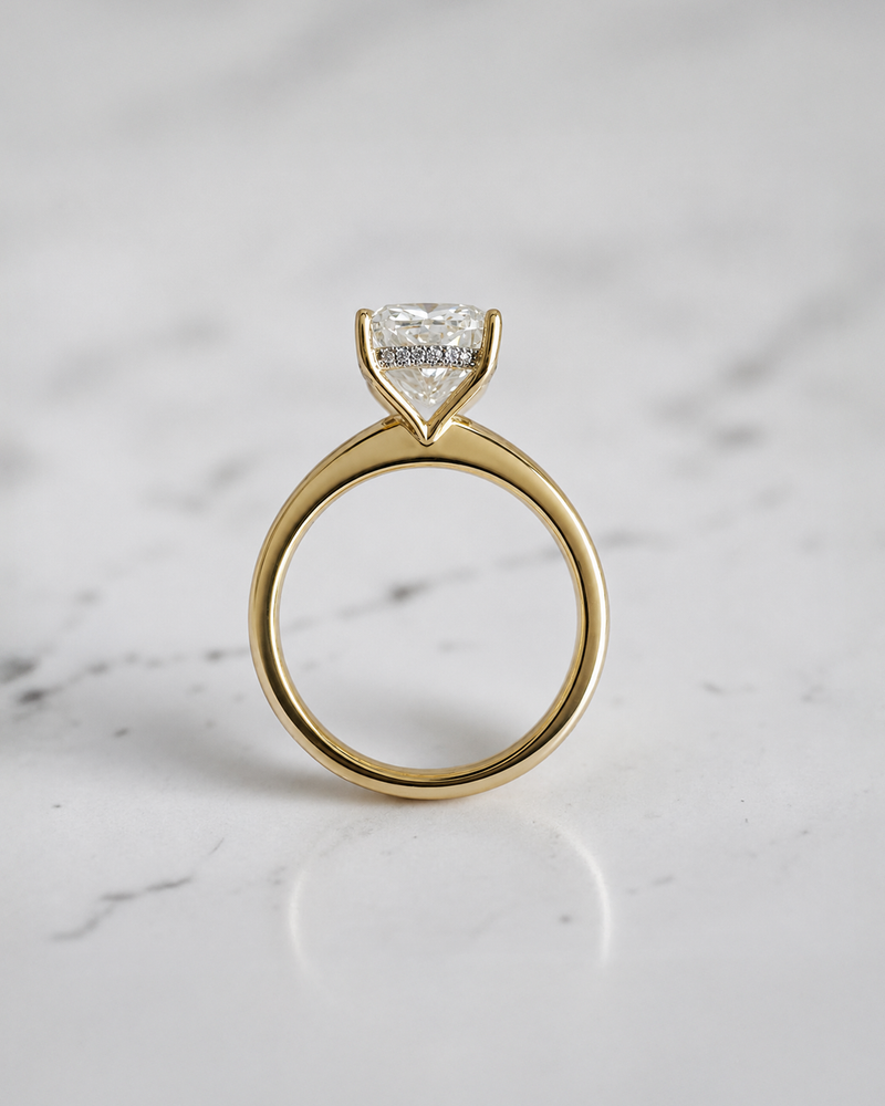 4ct elongated cushion cut lab grown diamond hidden halo solitaire engagement ring in yellow gold with floating cathedral style setting, handmade in London.