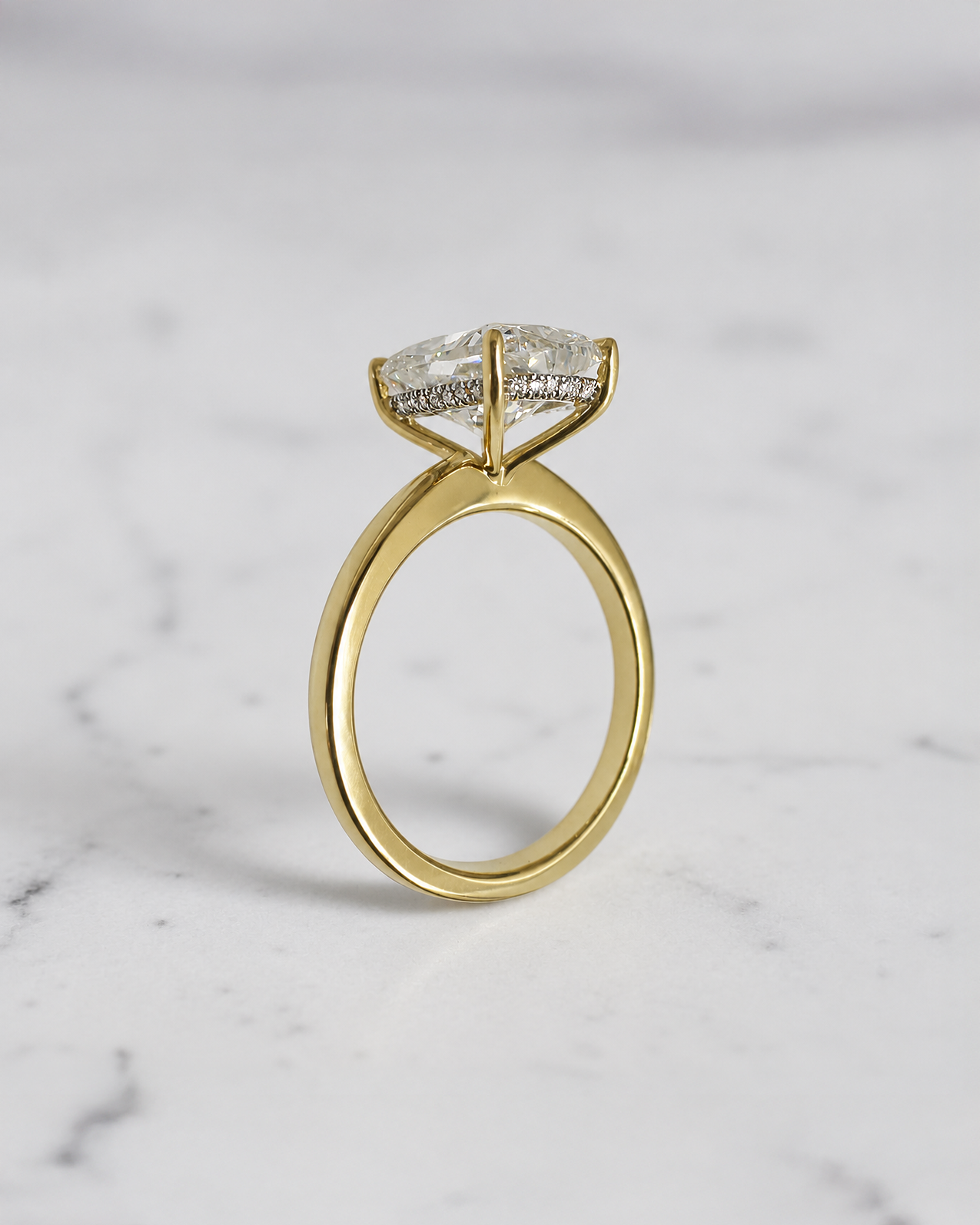 4ct elongated cushion cut lab grown diamond hidden halo solitaire engagement ring in yellow gold with floating cathedral style setting, handmade in London.