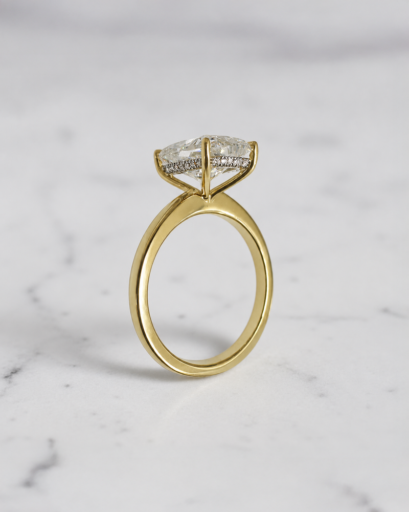 4ct elongated cushion cut lab grown diamond hidden halo solitaire engagement ring in yellow gold with floating cathedral style setting, handmade in London.