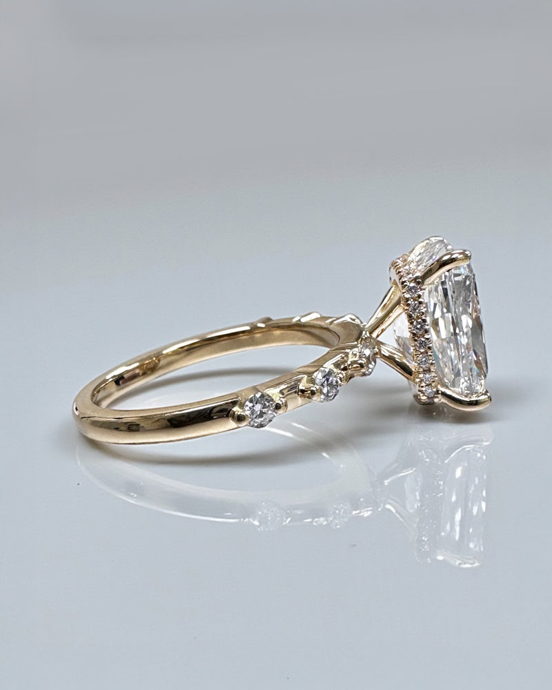 4ct elongated cushion cut lab grown diamond engagement ring with spaced diamond band and hidden halo in 18kt gold 