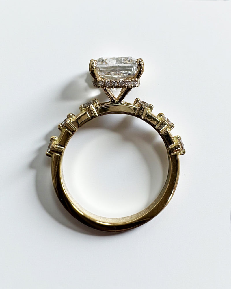 4ct elongated cushion cut lab grown diamond engagement ring with spaced diamond band and hidden halo in 18kt gold 