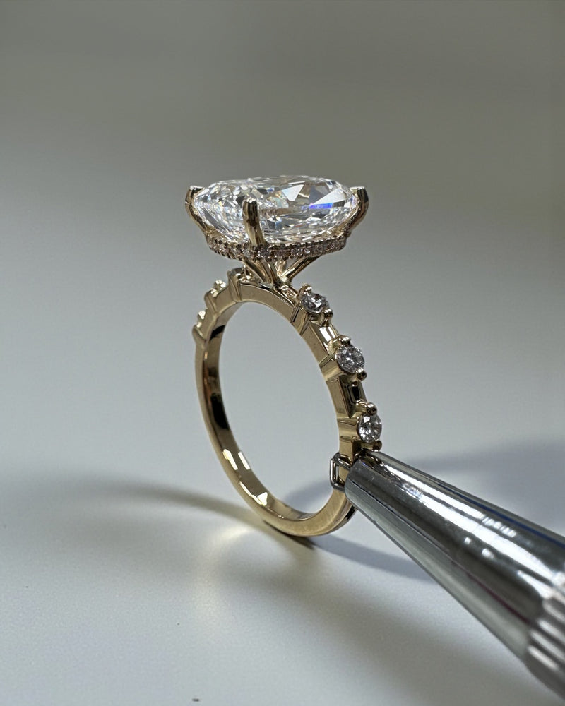 4ct elongated cushion cut lab grown diamond engagement ring with spaced diamond band and hidden halo in 18kt gold close up