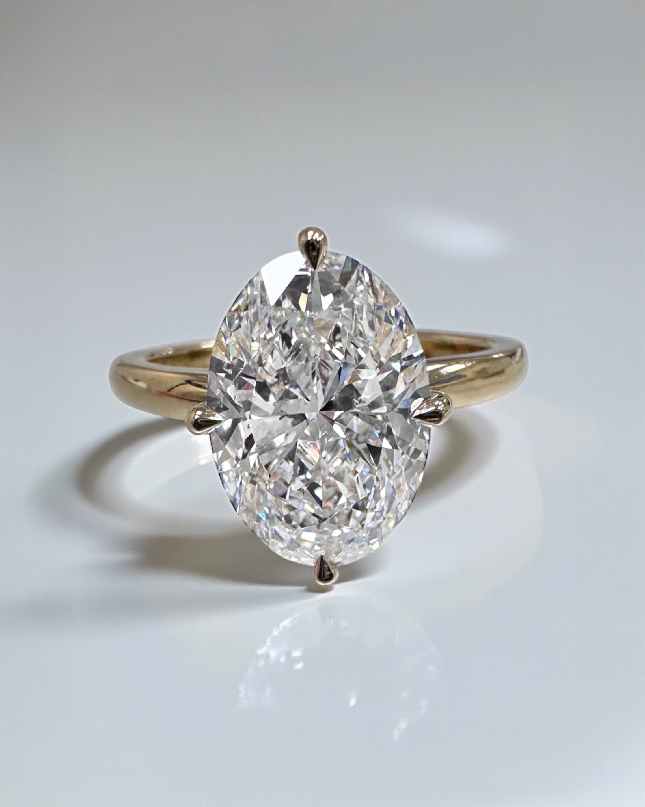 Oval 4ct lab grown diamond solitaire in compass prong setting engagement ring by Layla Diamonds London, 18kt Yellow Gold