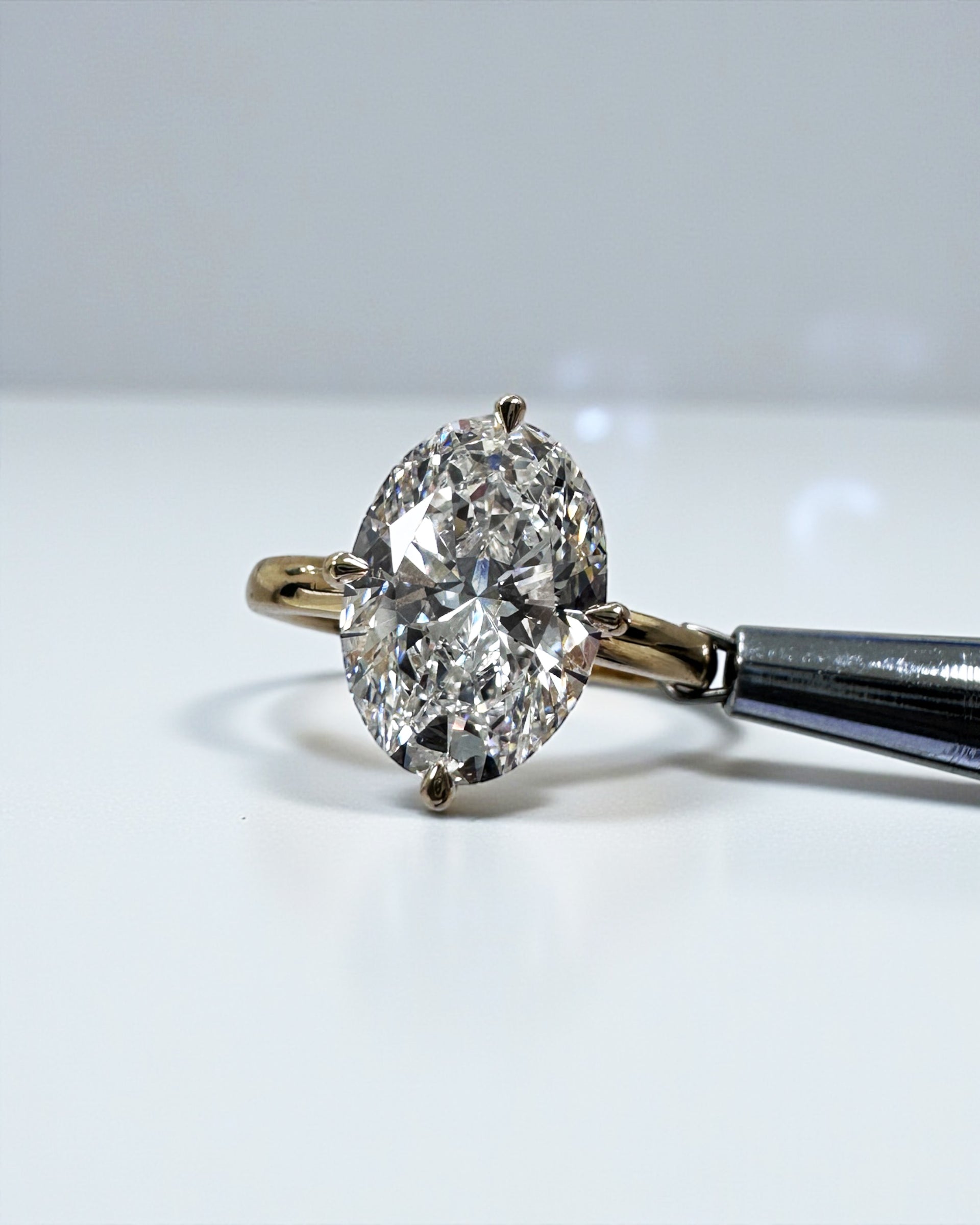 Oval 4ct lab grown diamond solitaire in compass prong setting engagement ring by Layla Diamonds London, 18kt Yellow Gold