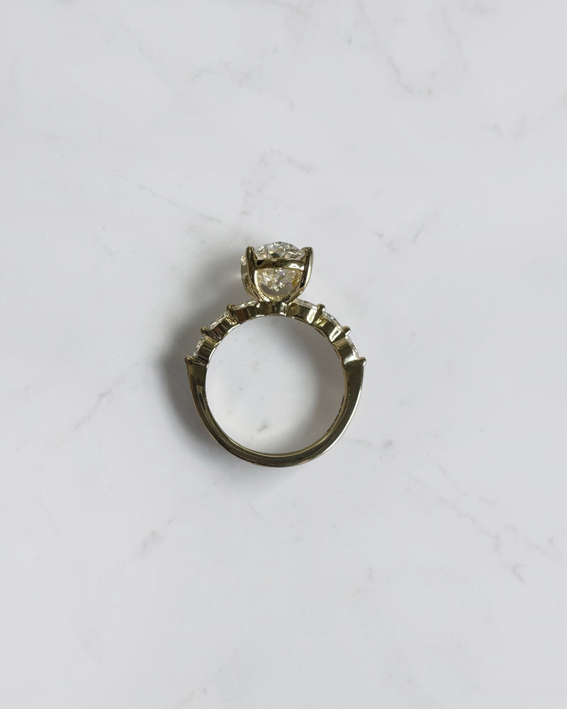 4ct oval cut lab grown diamond engagement ring with marquise cut diamond band in yellow gold, four claw setting, 4.40ct total diamond weight, handcrafted in London