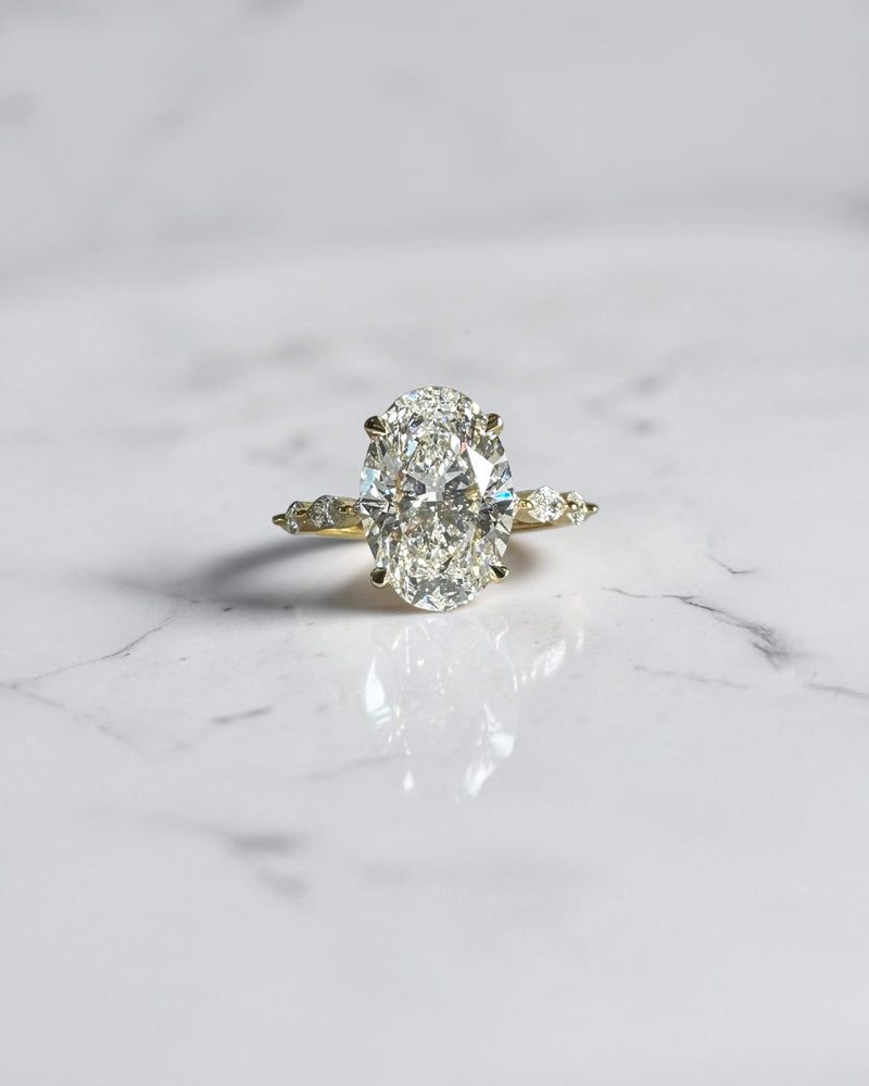 4ct oval cut lab grown diamond engagement ring with marquise cut diamond band in yellow gold, four claw setting, 4.40ct total diamond weight, handcrafted in London