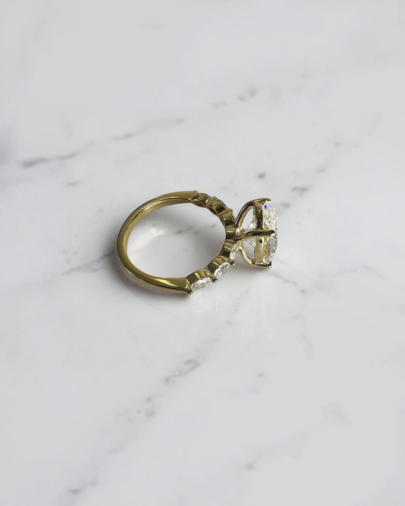 4ct oval cut lab grown diamond engagement ring with marquise cut diamond band in yellow gold, four claw setting, 4.40ct total diamond weight, handcrafted in London