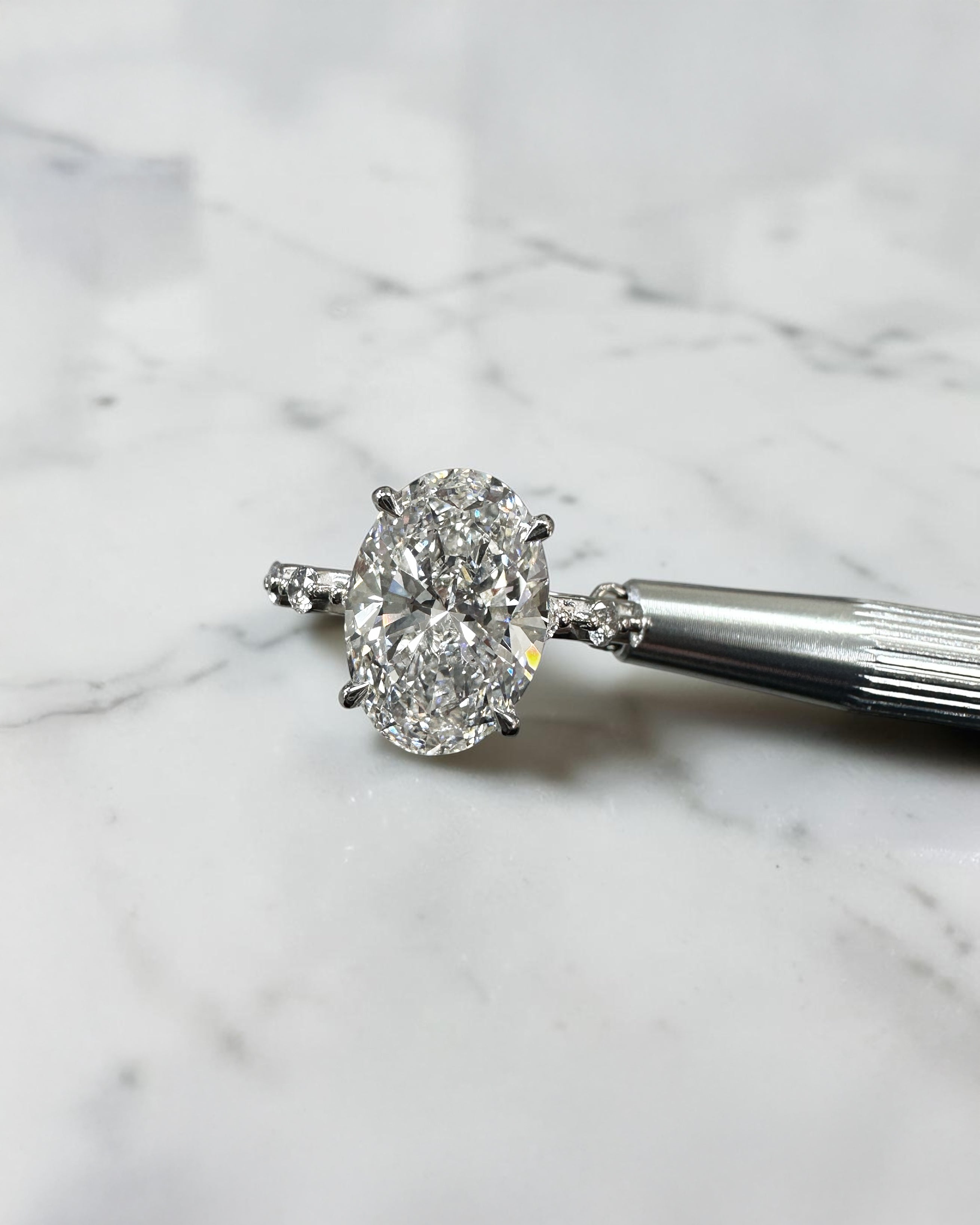 4ct oval lab grown diamond hidden halo engagement ring with floating cathedral setting and spaced diamond band in platinum.