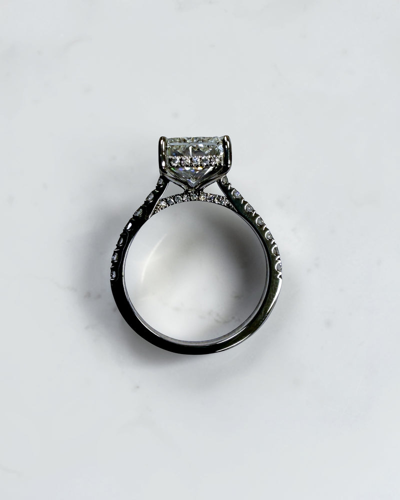 4ct radiant cut lab grown diamond engagement ring with cathedral setting, hidden halo and diamond band. Available in platinum or 18kt yellow or white gold