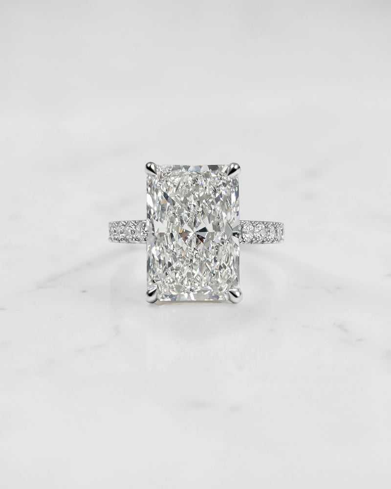 4ct radiant cut lab grown diamond engagement ring with cathedral setting, hidden halo and diamond band. Available in platinum or 18kt yellow or white gold