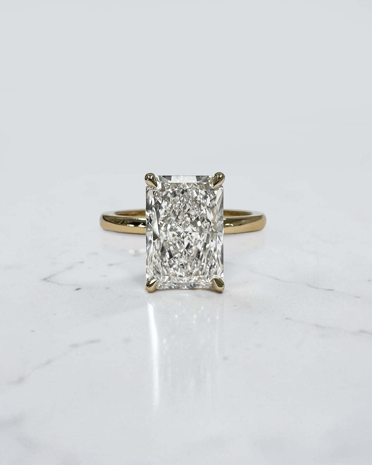 4ct radiant cut lab grown diamond engagement ring with floating setting and wrap around hidden halo 18kt yellow gold