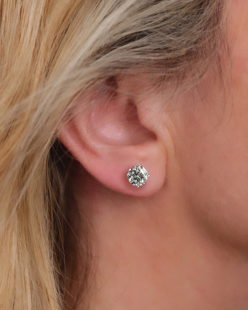 4ct round brilliant lab grown diamond martini stud earrings featuring 2ct E VVS2+ diamonds in a classic four prong martini setting with secure butterfly backs.