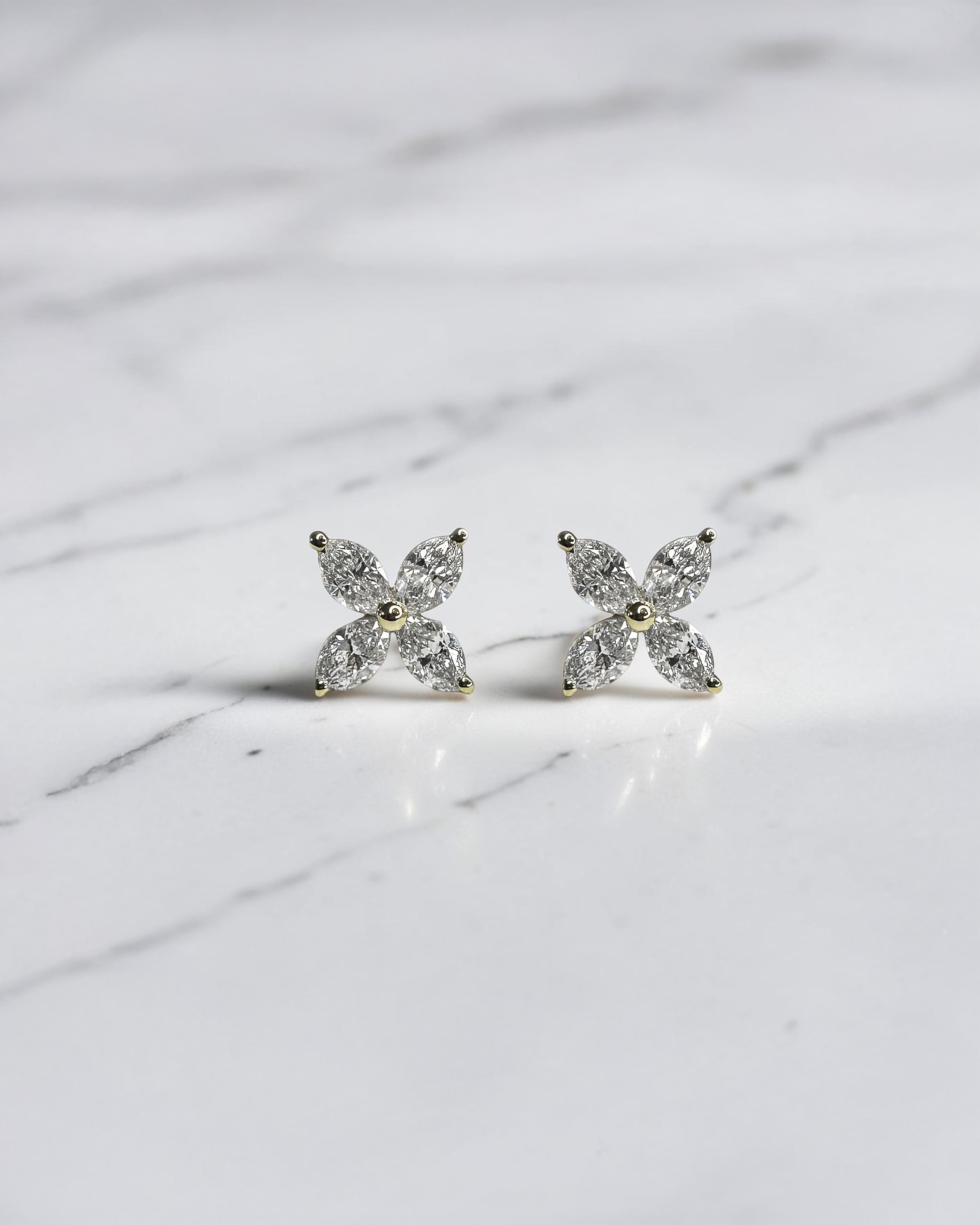 1.40ct marquise diamond flower stud earrings in yellow gold featuring four marquise cut diamonds per earring, available in lab grown or natural diamonds.