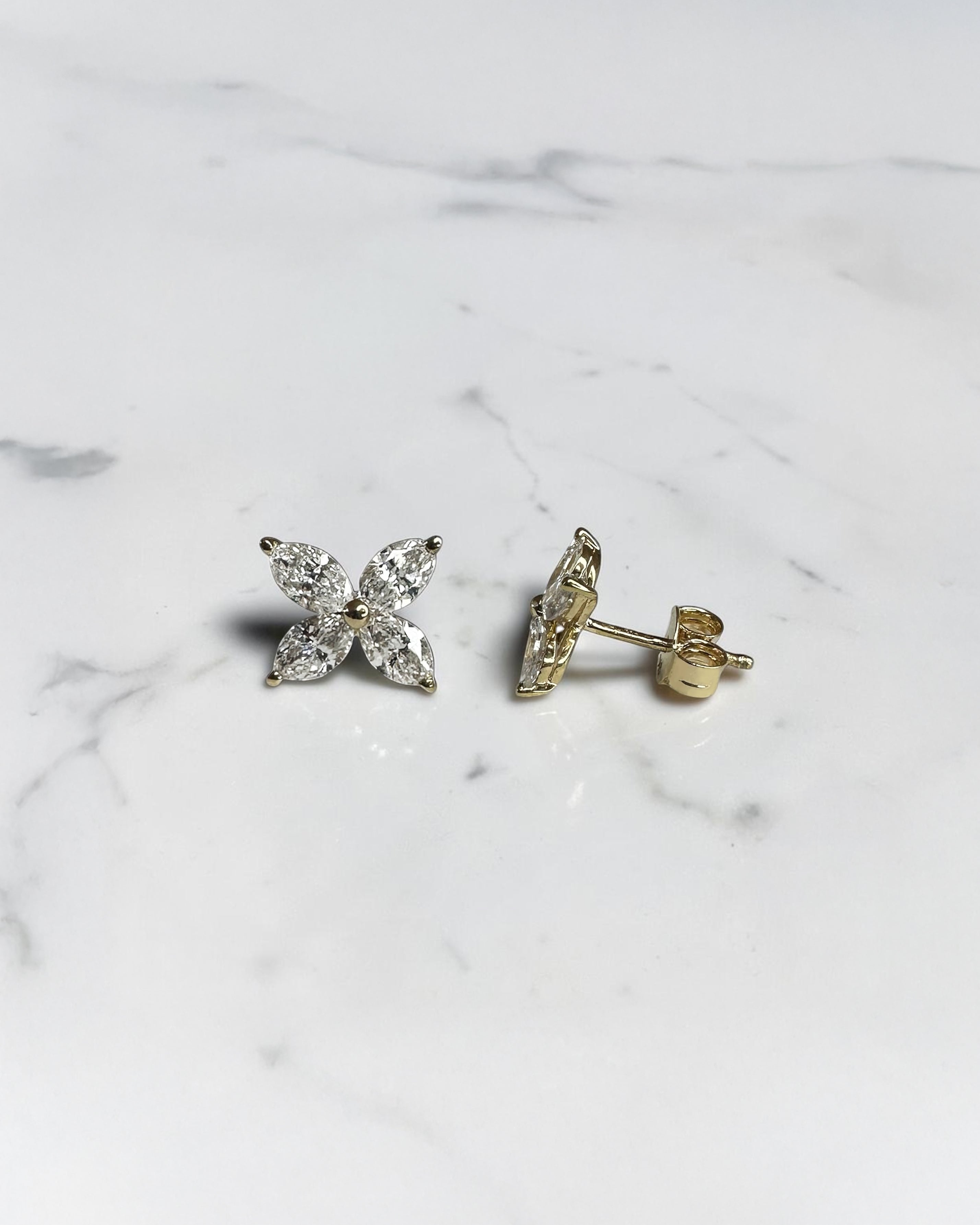 1.40ct marquise diamond flower stud earrings in yellow gold featuring four marquise cut diamonds per earring, available in lab grown or natural diamonds.