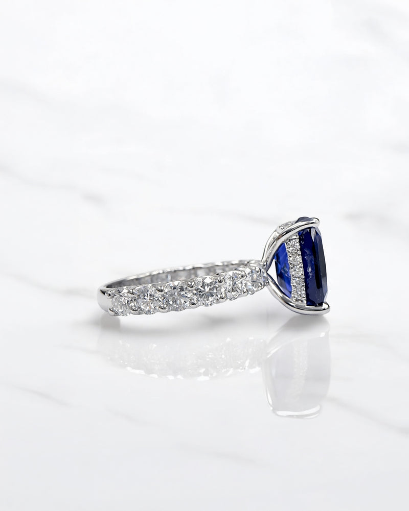 5.50ct cushion cut lab grown blue sapphire engagement ring with diamond hidden halo and 1.60ct lab grown diamond band in platinum.