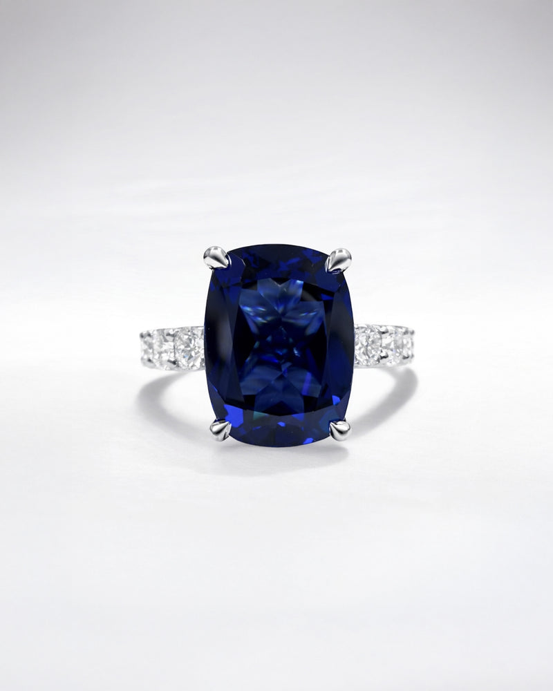 5.50ct cushion cut lab grown blue sapphire engagement ring with diamond hidden halo and 1.60ct lab grown diamond band in platinum.