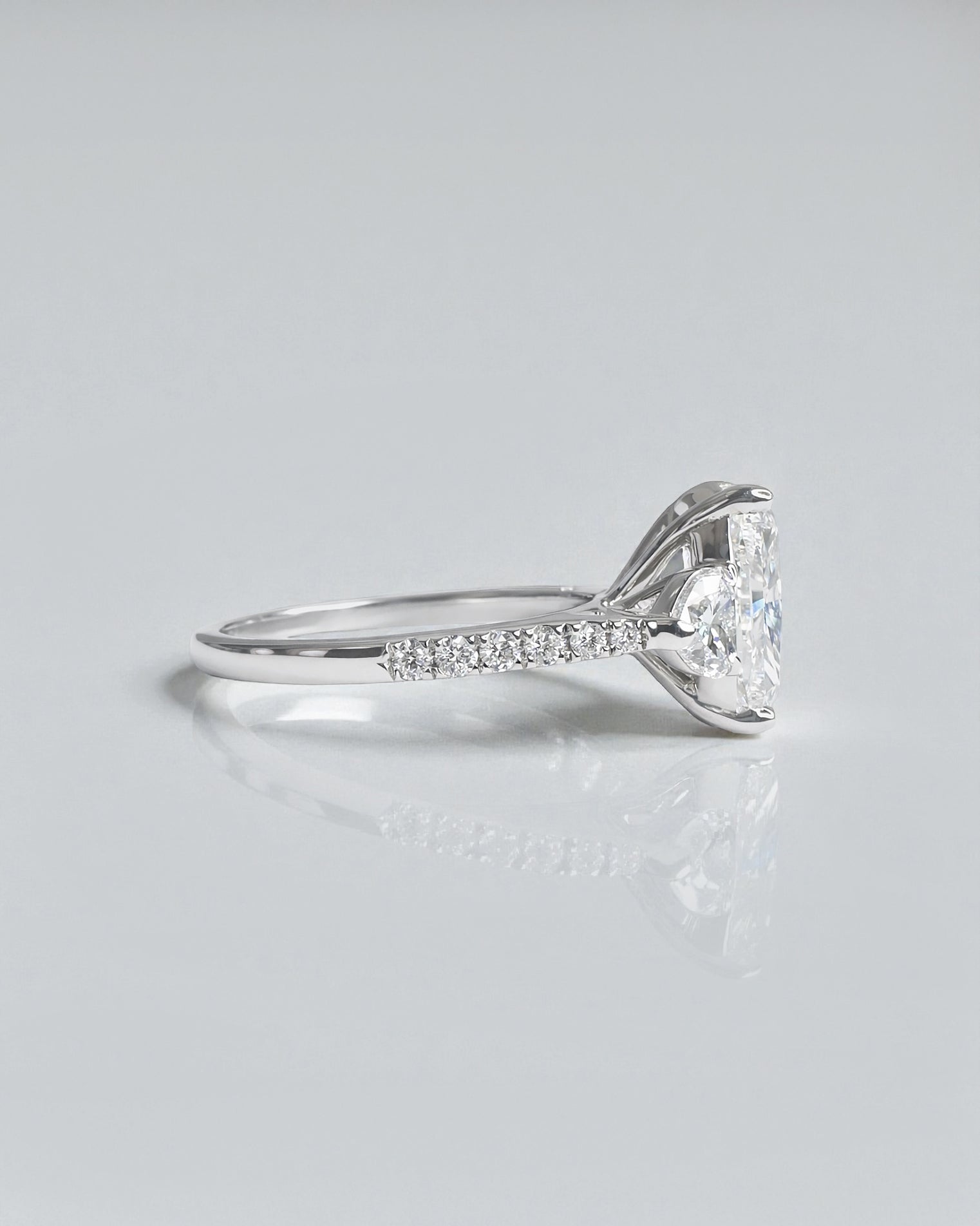 5ct radiant cut lab grown diamond engagement ring with heart side stones and diamond shoulders in polished platinum
