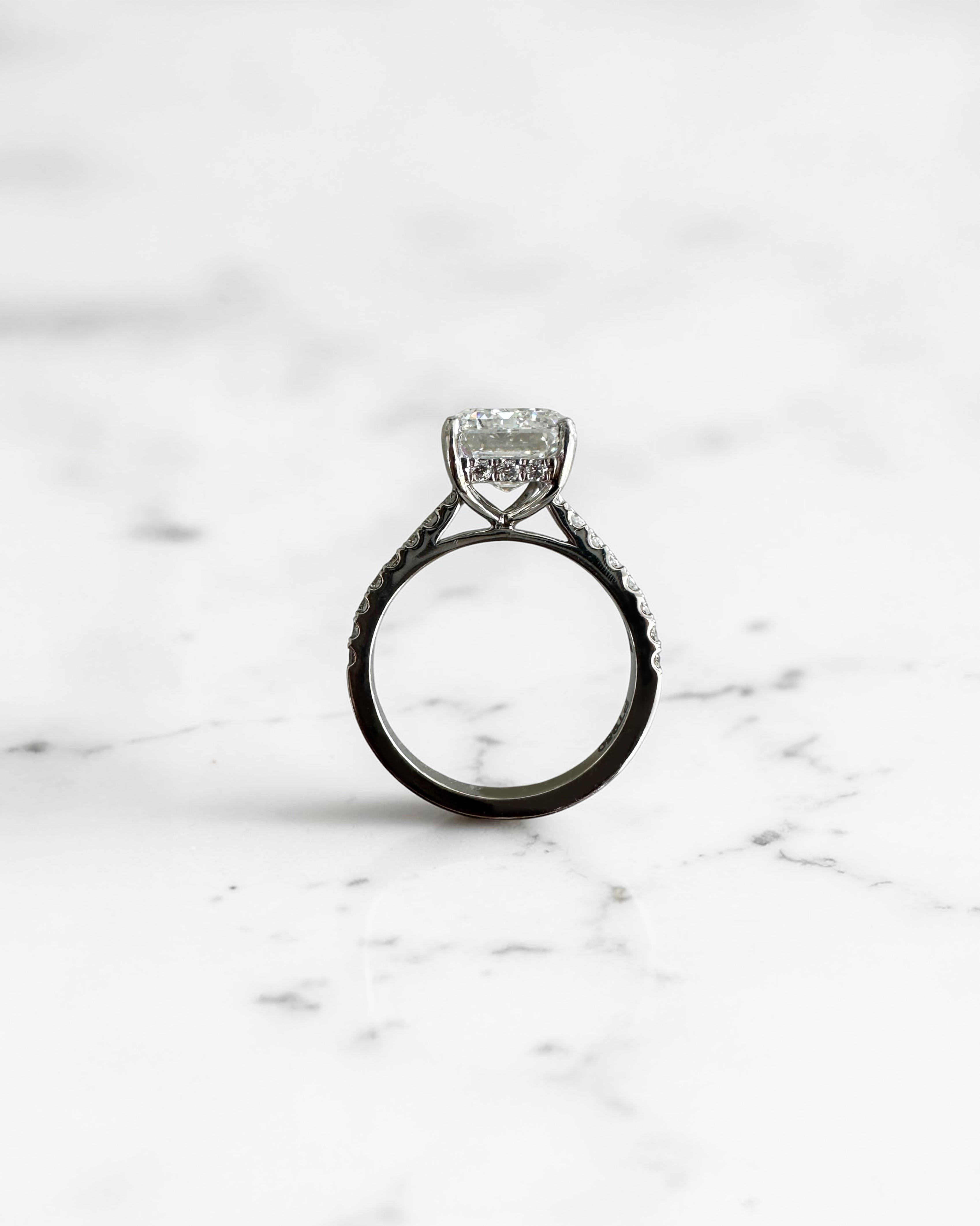 5ct emerald cut lab grown diamond engagement ring with cathedral setting, diamond shoulders, hidden halo and 5.45ct total diamonds by Layla Diamonds.