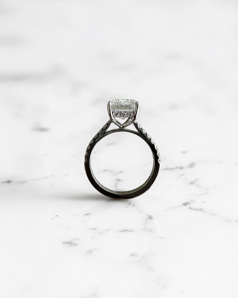5ct emerald cut lab grown diamond engagement ring with cathedral setting, diamond shoulders, hidden halo and 5.45ct total diamonds by Layla Diamonds.