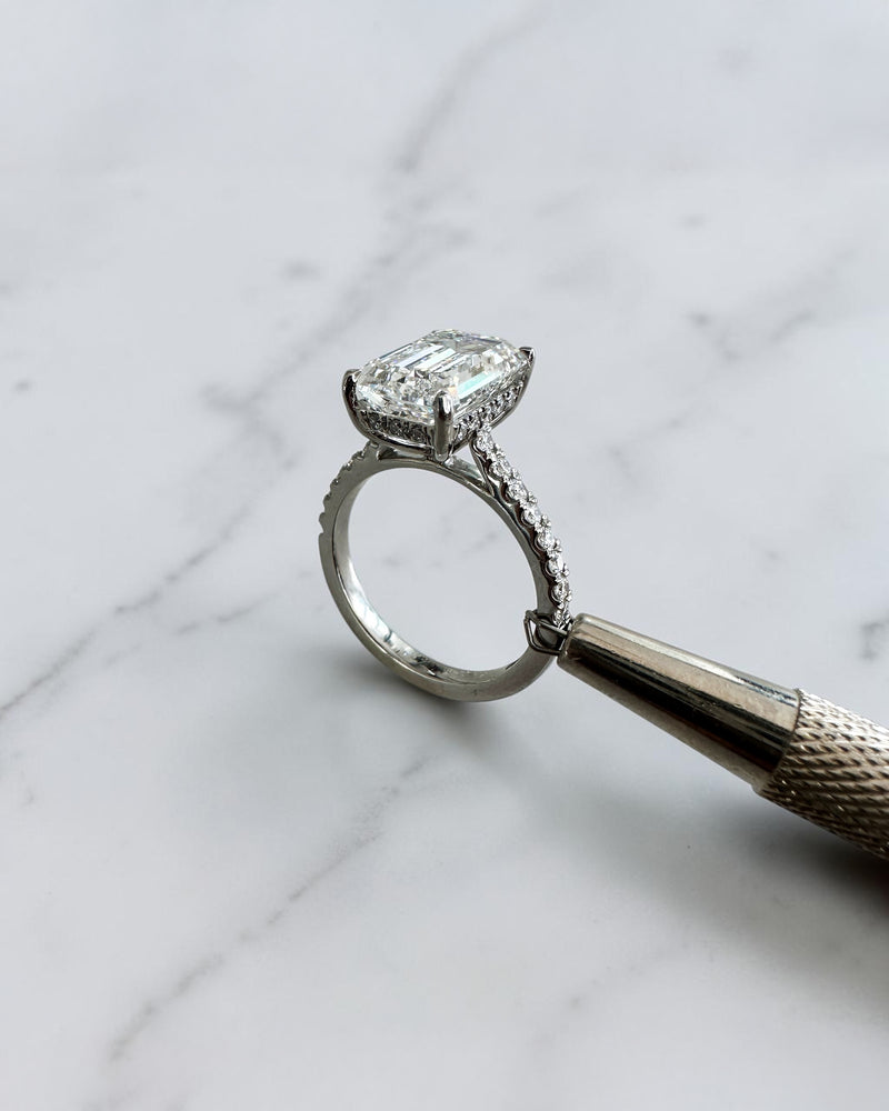5ct emerald cut lab grown diamond engagement ring with cathedral setting, diamond shoulders, hidden halo and 5.45ct total diamonds by Layla Diamonds.