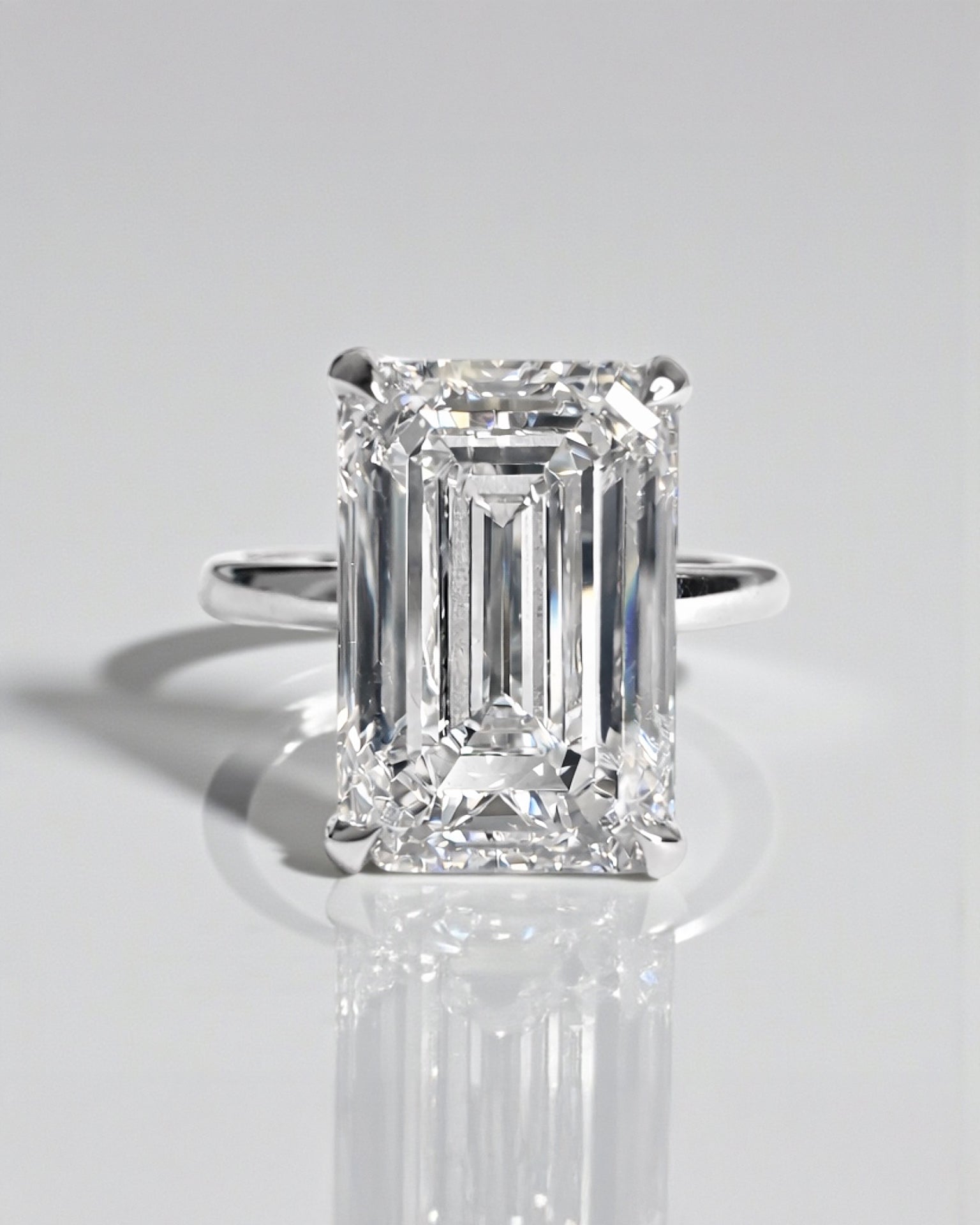 Emerald cut lab grown diamond solitaire engagement ring with hidden halo, 5ct centre stone. 9kt white gold, 18kt white gold, platinum