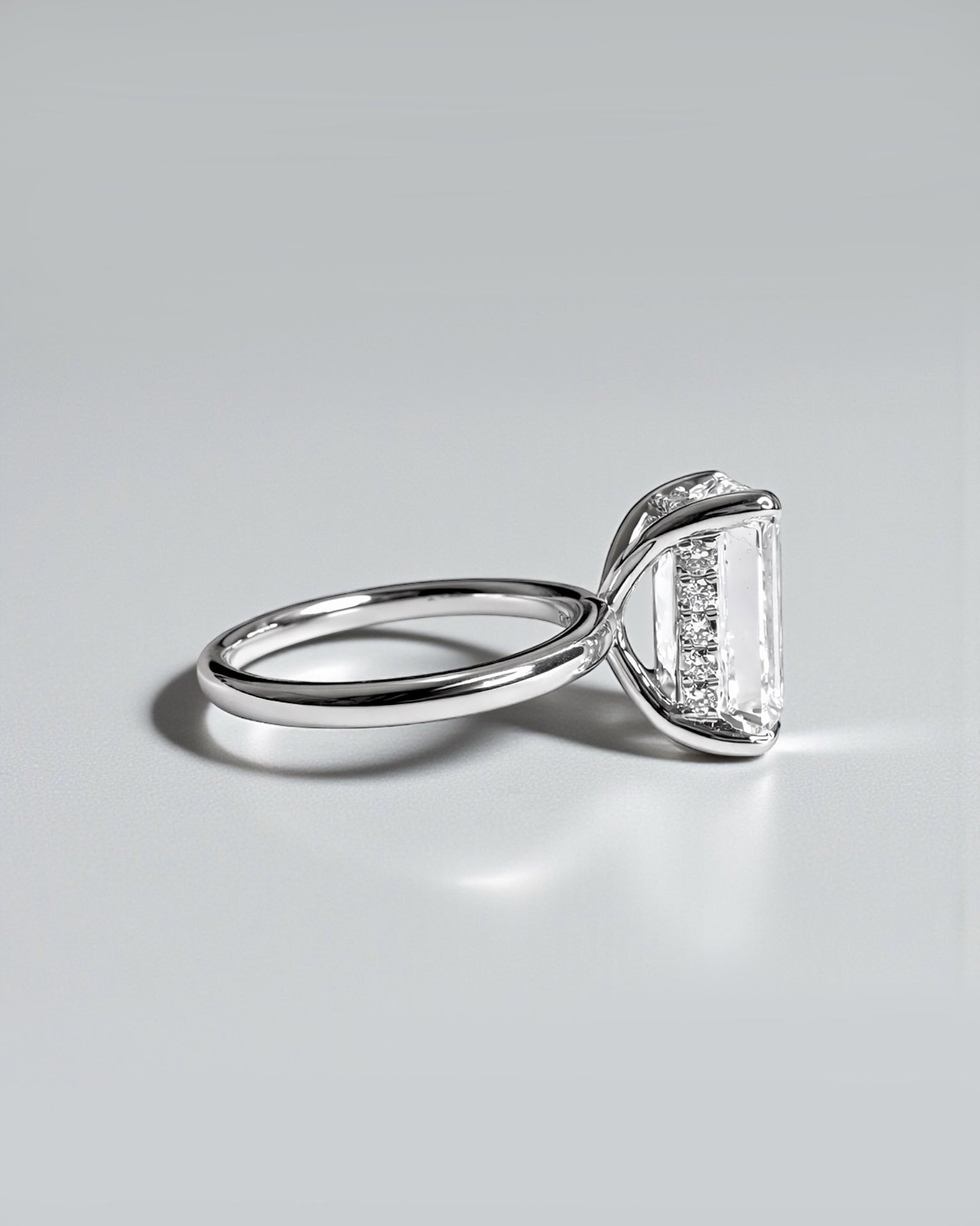 Emerald cut lab grown diamond solitaire engagement ring with hidden halo, 5ct centre stone. 9kt white gold, 18kt white gold, platinum