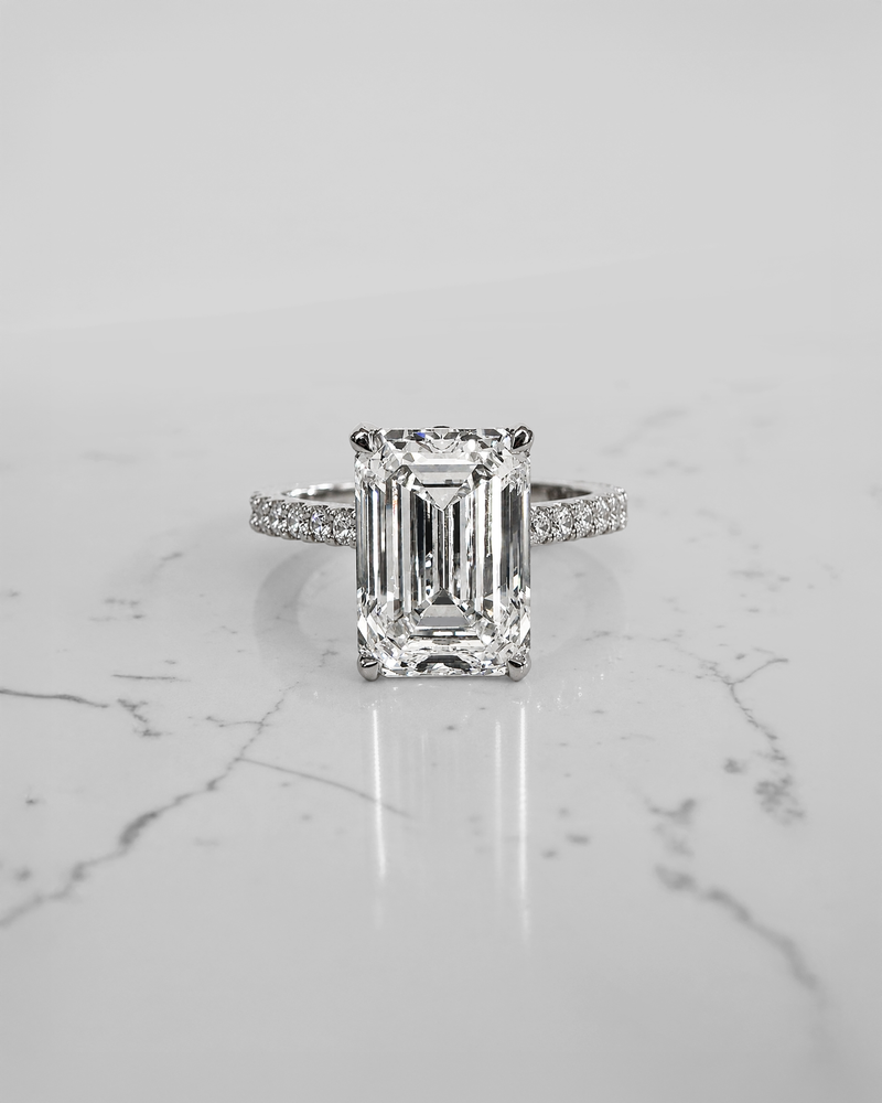 5ct emerald cut lab grown diamond engagement ring with cathedral setting, diamond shoulders, hidden halo and 5.45ct total diamonds by Layla Diamonds.